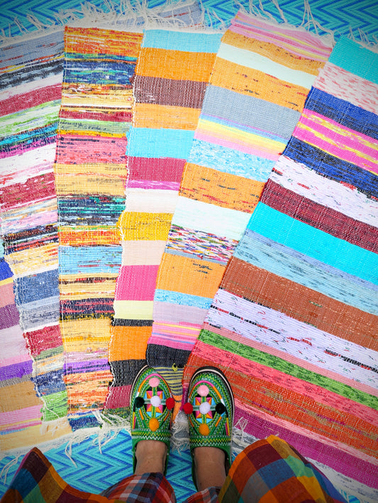 Made from surplus fabrics produced from the garment industry, these chindis are a fabulous splash of colour to a multitude of spaces and purposes! Great on the floor as a bath, door or floor mat or as a chair saver and handily machine washable!
Due to their reuse and recycle nature, we cannot be absolutely sure about all fabrics included in each piece, so we advise either salt fixing in the
Materials commonly recycled