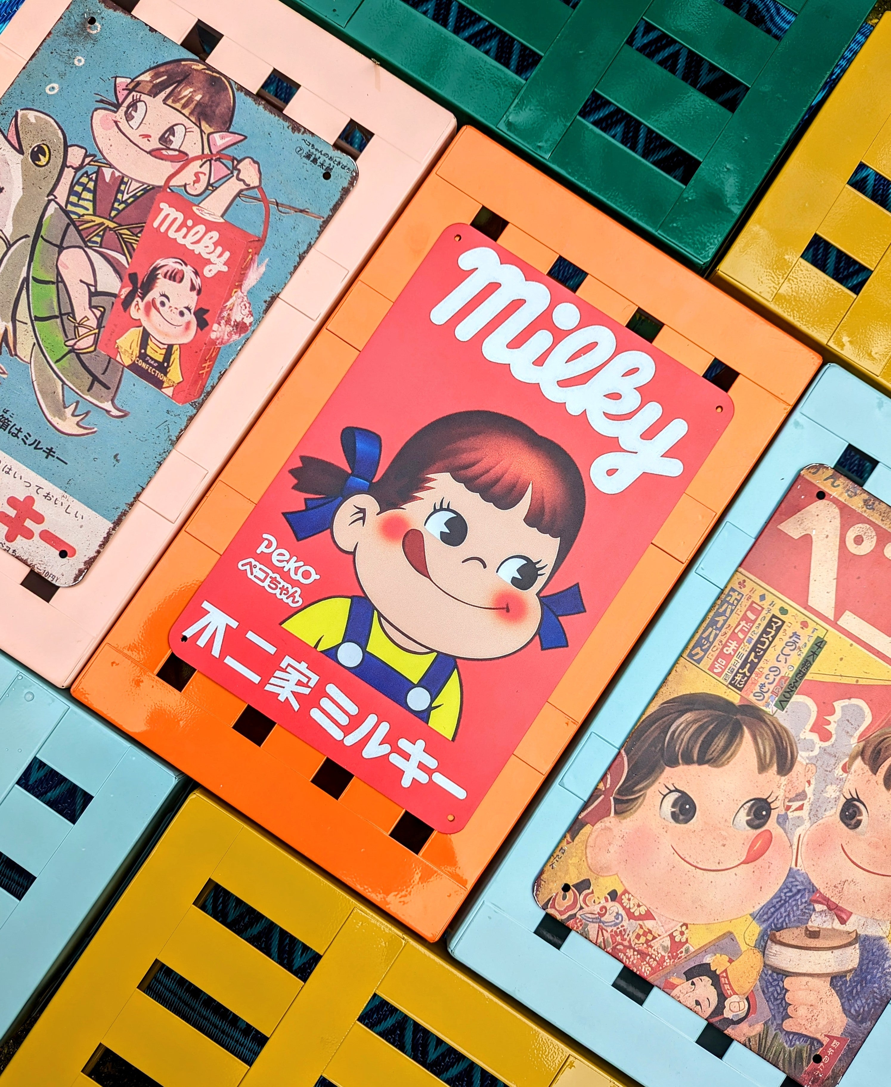 Japan's best vintage Peko Milky sweets advertising graphics printed on a tin sign!, what fantastic cheeky faces those kids have got!!

Great up on the wall or even tile behind a sink or cooker with them for a bit of eye joy!!

20x30cm

Printed tin

Not original vintage.