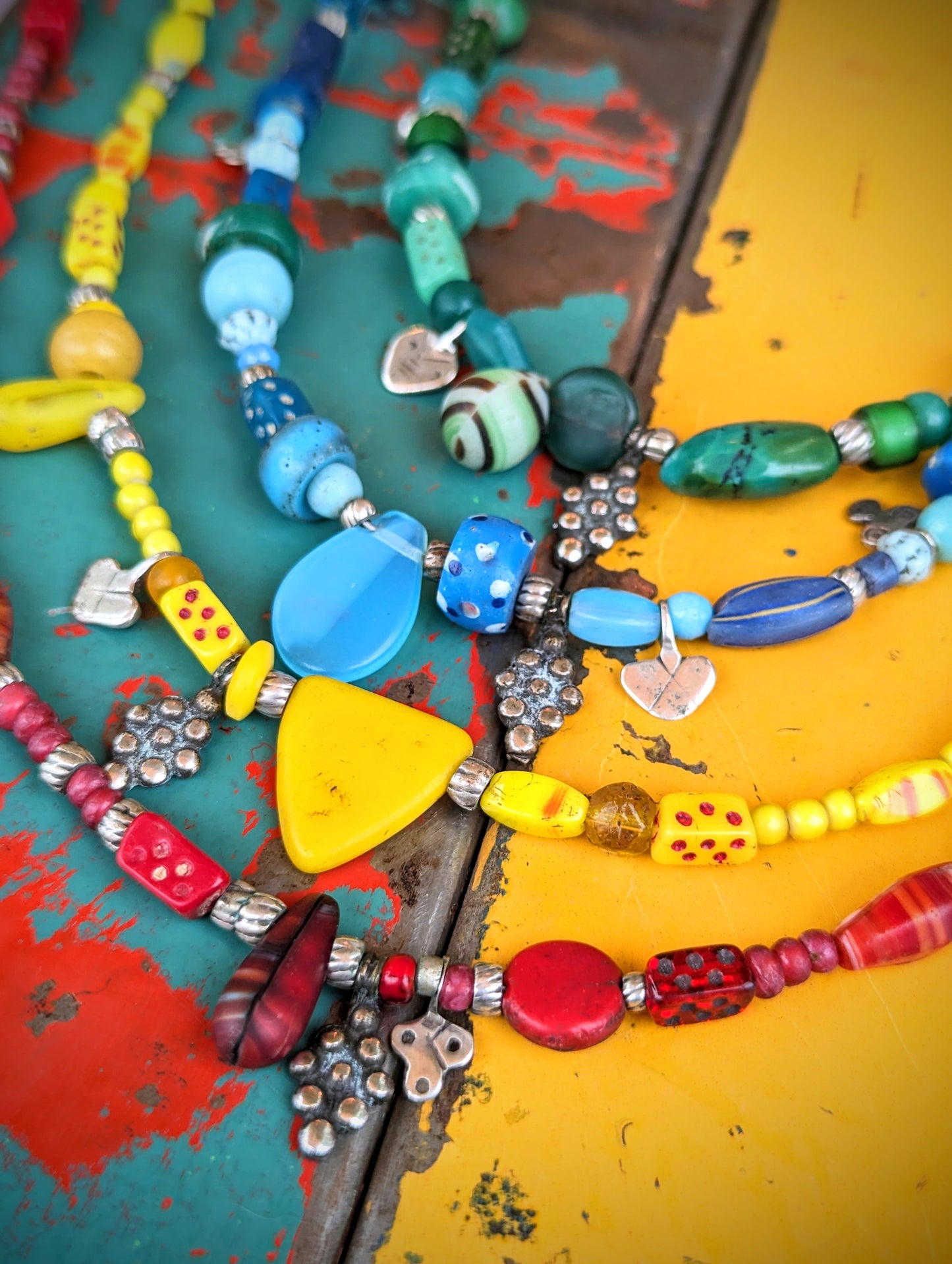 Antique and vintage Bohemian and Venetian glass trade beads all different shapes and sizes, including beautiful delicate dice beads, threaded with all different, all unique, antique Saharan Africa silver pendants and beads.
All necklaces have a silver S hook clasp.
Approx 48cm long