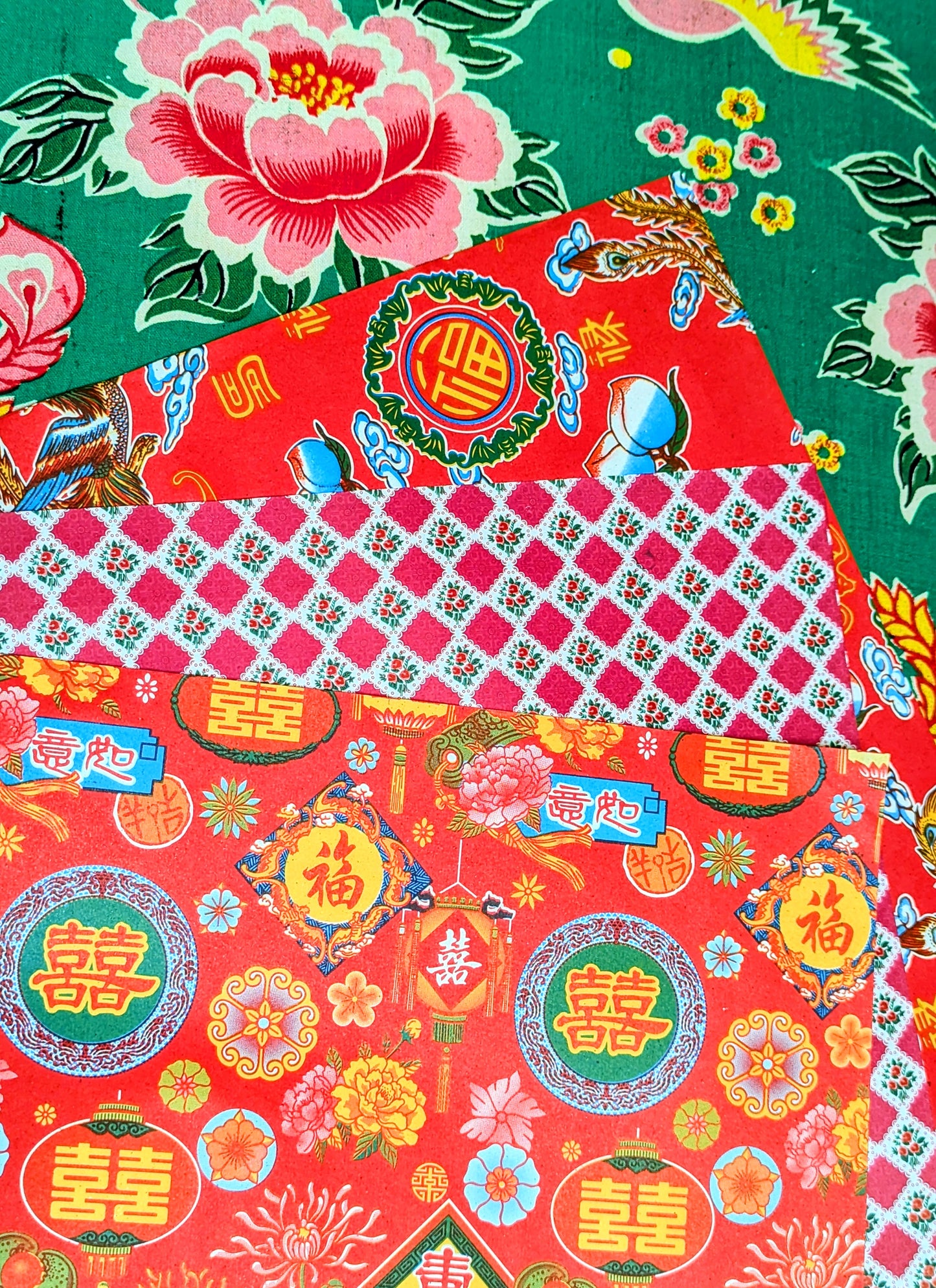 Gorgeous, super kitsch traditional Chinese festival papers, with lucky peaches and bats, strong dragons and light giving lanterns! Lightweight, great for wrapping presents, collage, scrapbooking, lining drawers, wallpapering dollhouses and paper mache.
These are used in traditional Chinese paper mache work to cover boxes, lampshades and containers, and the same designs have been made since the 1930s.
44x38.5cm approx , 3 sheets same design.
Lightly folded.