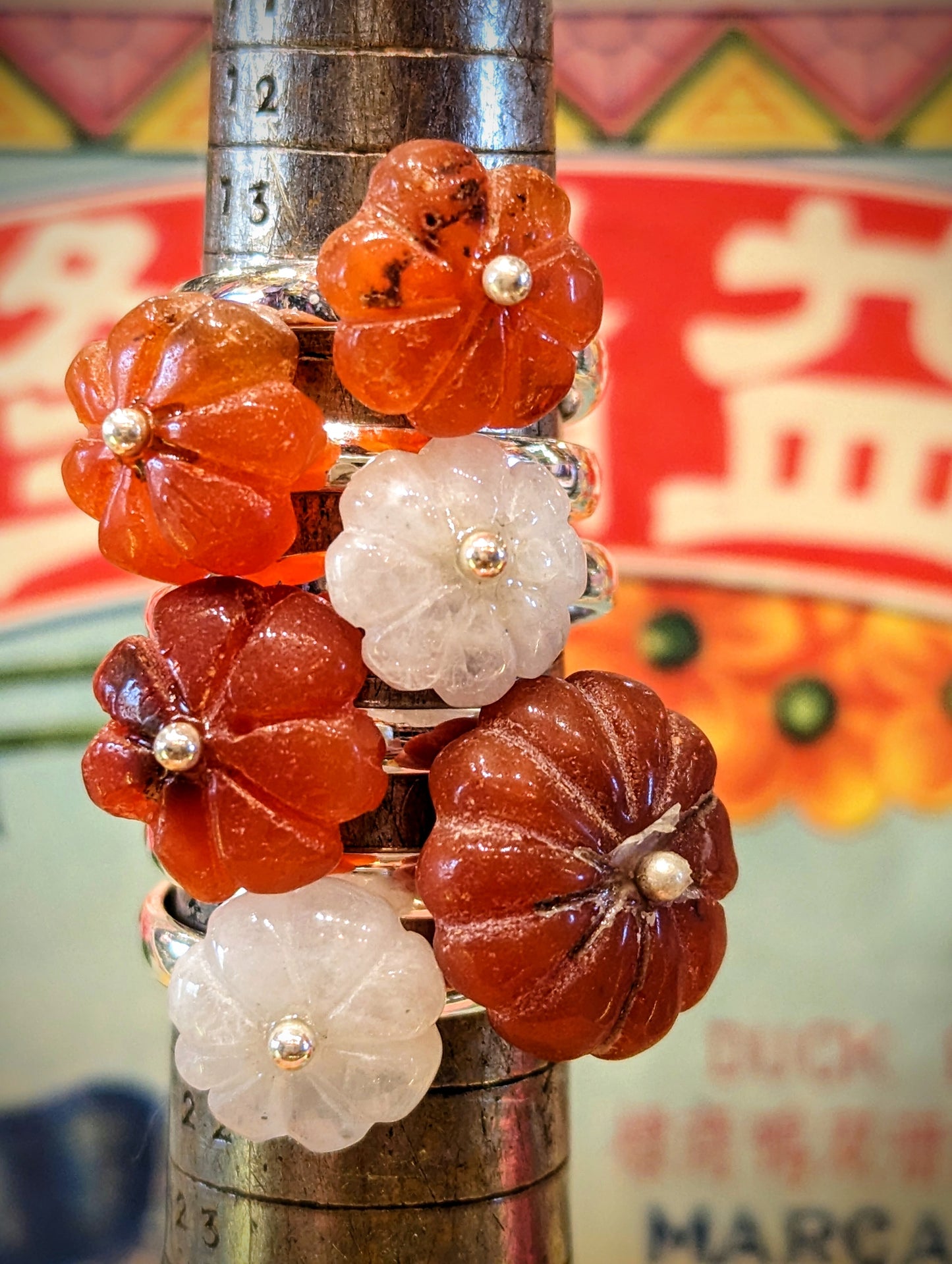 Floral carved carnelian.. This semi precious stone have is an aid to creativity amongst other things!. We source stones directly, choosing every one to be made into rings in India, such a juicy job!
These are made by hand from silver.
Stones are all individually but are approx 15mm diameter.
Numbered from top to bottom , pictured with moonstone rings,but these have their own page so are not numbered below.