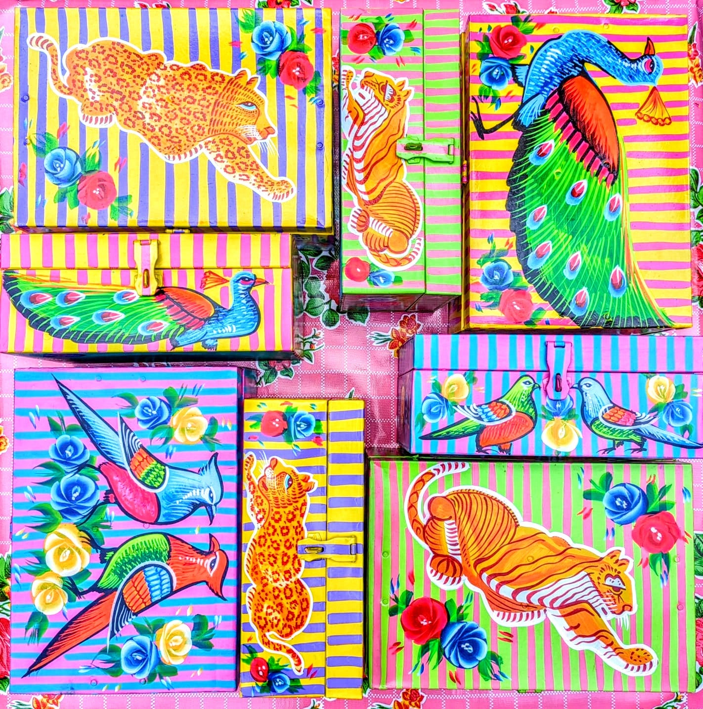 Handpainted in Pakistan by the artisans that paint the fabulously flamboyant trucks! These beautiful boxes are painted with heavy duty enamel paints onto steel cases.Use for jewellery, sewing, knitting, or even just to hide all the paperwork or gubbins you just don't want to see!! Suitable for light cool water washing only. Due to their handmade production, designs may vary and also have imperfections.

Sold individually. 

Dimensions large size are 30cm x 20cm x 13cm

Dimensions small size are 25cm x 16.5c