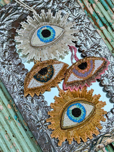 Gorgeous protective all seeing eyes hanging decoration with hand embroidered metallic wirework, and beautiful beads and sequins, sumptuous beauty!!

A lovely decoration, or luxe addition to a special gift!

Small 11 x 6  cm

Large 13 x 11 cm
Cody Foster & Co 