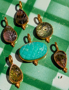 
A gorgeous selection of hand carved stones we collected in Jaipur, Rajasthan, all set in fancy silver bezel or bobbles, and gold plated in pure , butter yellow Indian gold to make loveliest pendants, something for everyone!!

1 tourmaline, 21 x 9mm
2 tourmaline,  21 x 8mm
3 citrine, 21 x 10mm
4 chrysoprase, 20 x 15mm
5 citrine, 20 x 8mm
6 tourmaline, 20 x 8mm

Sizes include pendant loop.

Remove when washing and keep away from perfume and creams to preserve plating.





