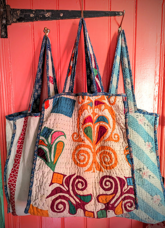 Beautiful ,strong,soft shoulder bags hand made from vintage kantha stitched quilts,which have been used,and washed for a generation or two before being lined with Gujarati indigo blockprint cotton and made into a really practical bag!!

Please be aware that due to the nature of upcycling fabrics, they may have some wear in places!

Size approx 40cm X 40cm X 15cm plus shoulder length strap

