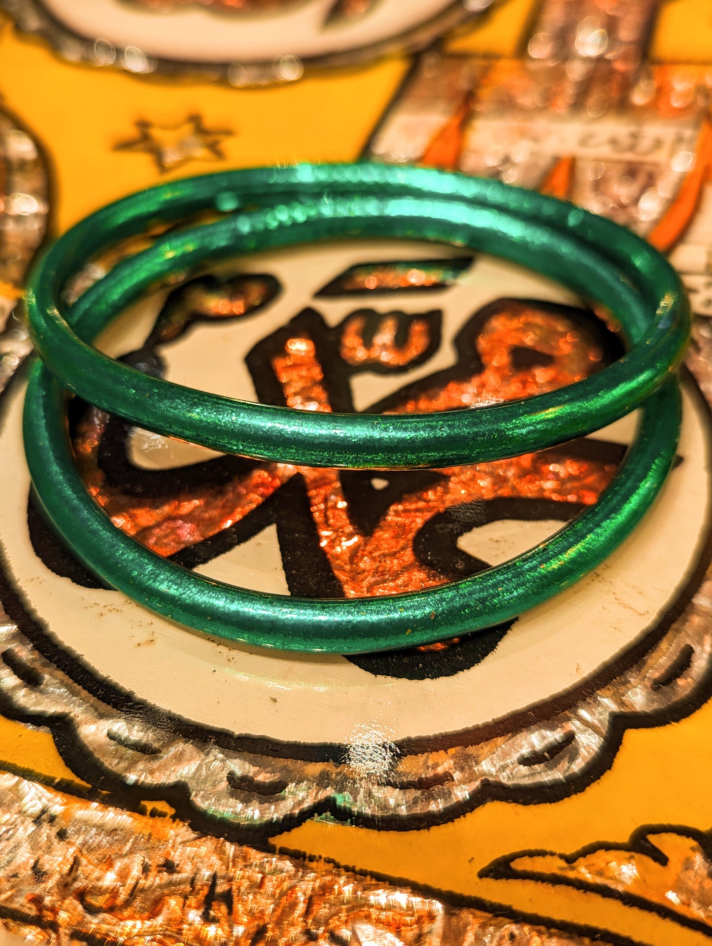 Wow, just look at the colours!!!Wonderful every day wear, waterproof, weightless bangles.

Crafted in Thailand , these are made from tubing lined by hand with real coloured gold leaf, the same as is used on Buddha statues.  Wear them swimming, working, playing and  you never lose the glam, disco dolly shine!

Made of medical grade tubing and coloured gold leaf..

Size nside diameter 6cm


