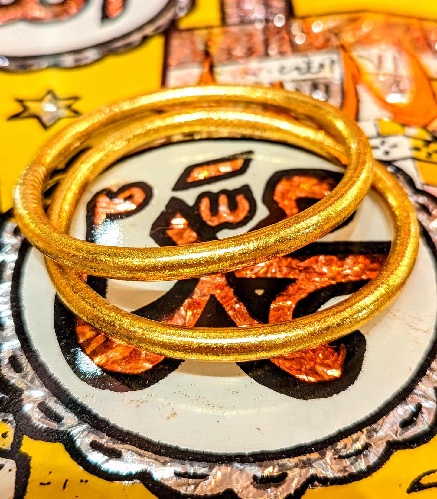 Wonderful every day wear, waterproof, weightless bangles.

Crafted in Thailand , these are made from tubing lined by hand with real gold leaf, the same as is used on Buddha statues.  Wear them swimming, working, playing and  you never lose the glam, gold shine!

Made of medical grade tubing and gold leaf..

Medium inside diameter 6cm

Large inside diameter 6.5cm

buddha bangle
