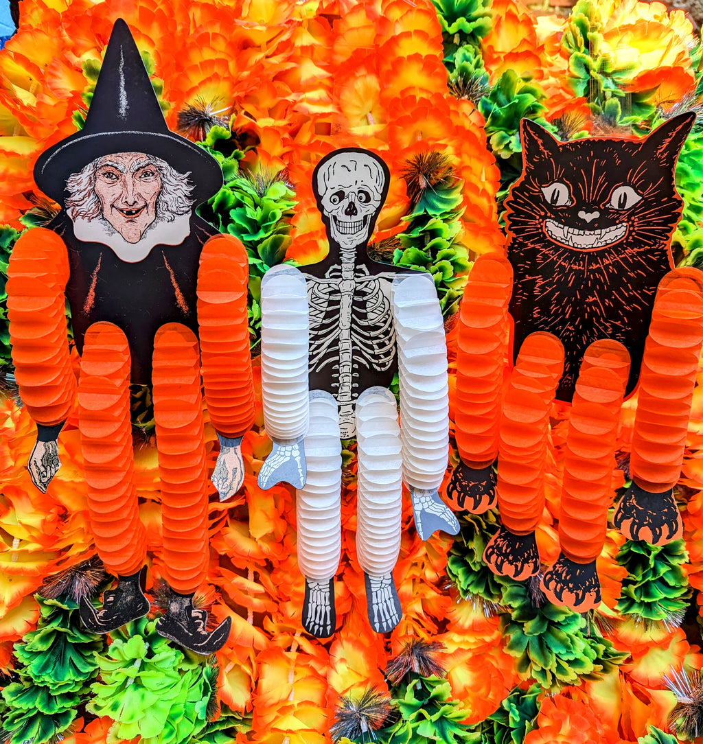 Hilarious American 1960s style, beautifully illustrated witch, black cat, and skeleton with honeycomb tissue arms and legs that move in the slightest breeze and shimmy and shake! 

Hang them in your windows or in your cupboards to create a scream!! 

Set of 3, cat, skeleton and witch.

36cm long each

Card and honeycomb tissue paper.