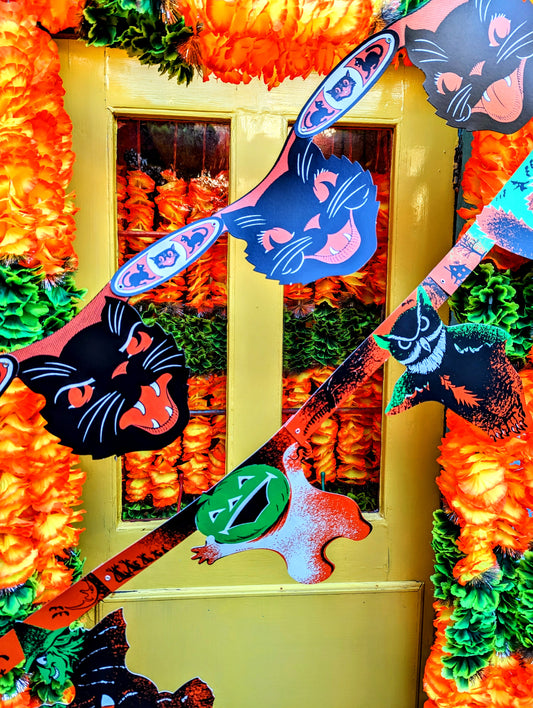 Terrifying American 1960s style, beautifully illustrated Halloween paper garlands to make you shake and shudder!!

Black cat garland 19cm X 122cm

Cats, witches and pumpkins 25cm x 211cm

Paper with metal rivets
Garland
Halloween garland
Vintage Halloween garland