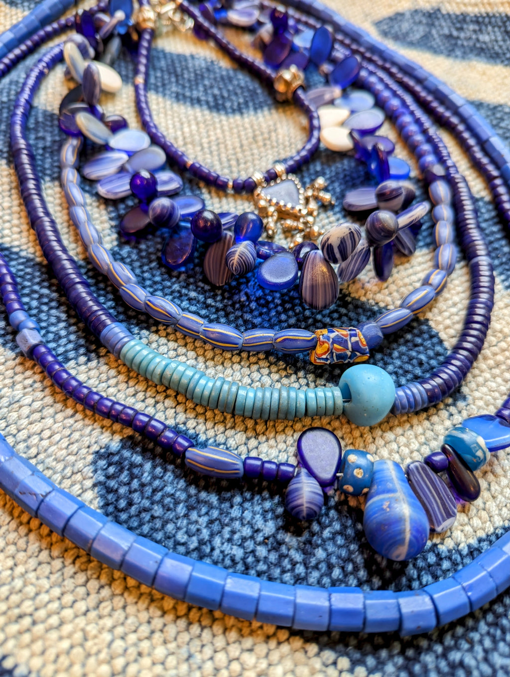 Heavenly antique Bohemian and Venetian glass trade bead necklaces all different shapes and sizes, but all in beautiful blue hues for all you indigo fanatics out there!!

All these glass beads were made between 1820-1932

Masai blue beads with silver Bohemian glass amulet 17" long

Fulani wedding beads, Bohemian glass, 17"long

Venetian blue/yellow stripe and millefiore bead 21" long

French padre, and blue dogon beads from Togo 24" long

Long Masai and Fulani beads 28" long

Ethiopian Bohemian glass 31" lon