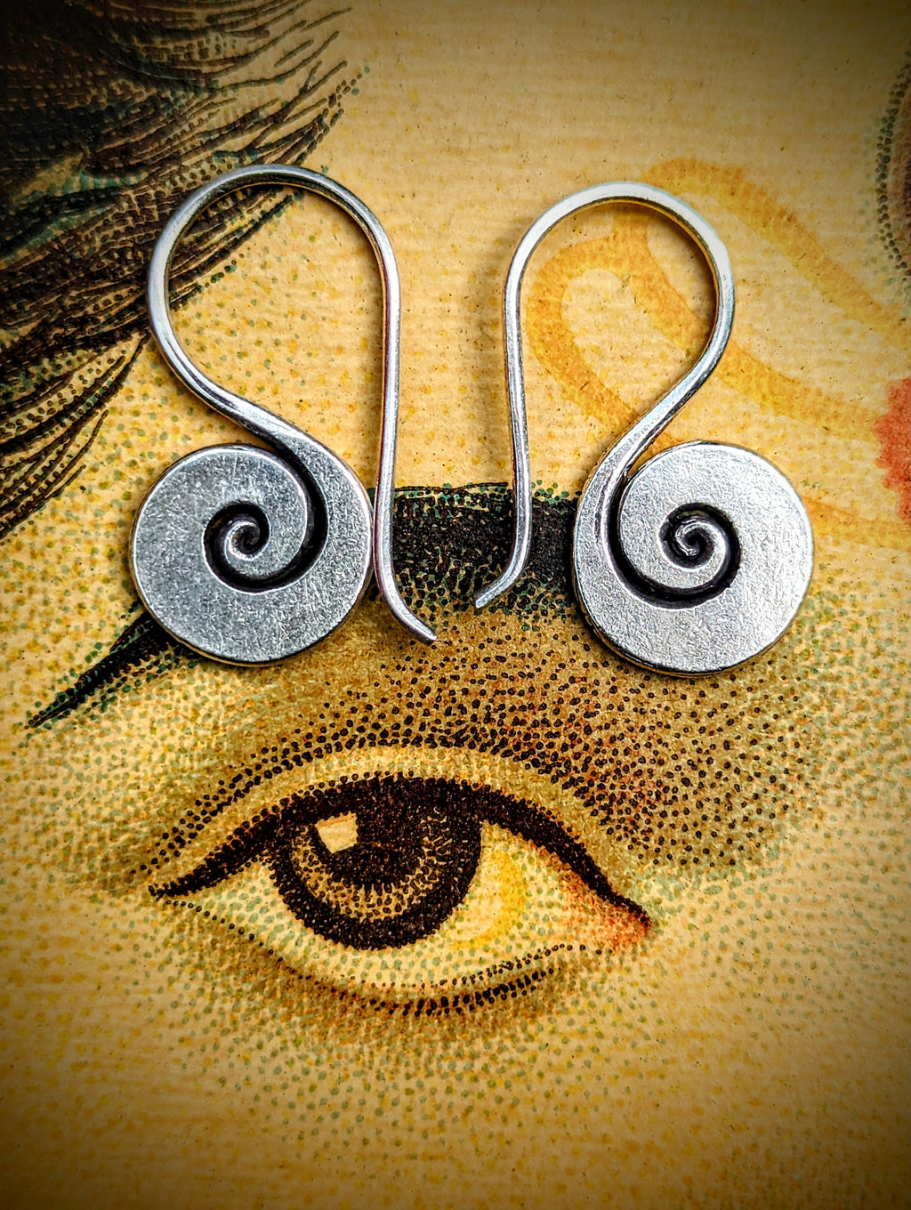 Handmade Burmese Karen earrings, beautiful matte, hand worked silver spirals with long hooks for a secure fit.

Karen Hill Tribe silver has a higher content of silver, at 99.5-99.9% compared with sterling silver at 92.5%.

Spiralis 1.5cm diameter.