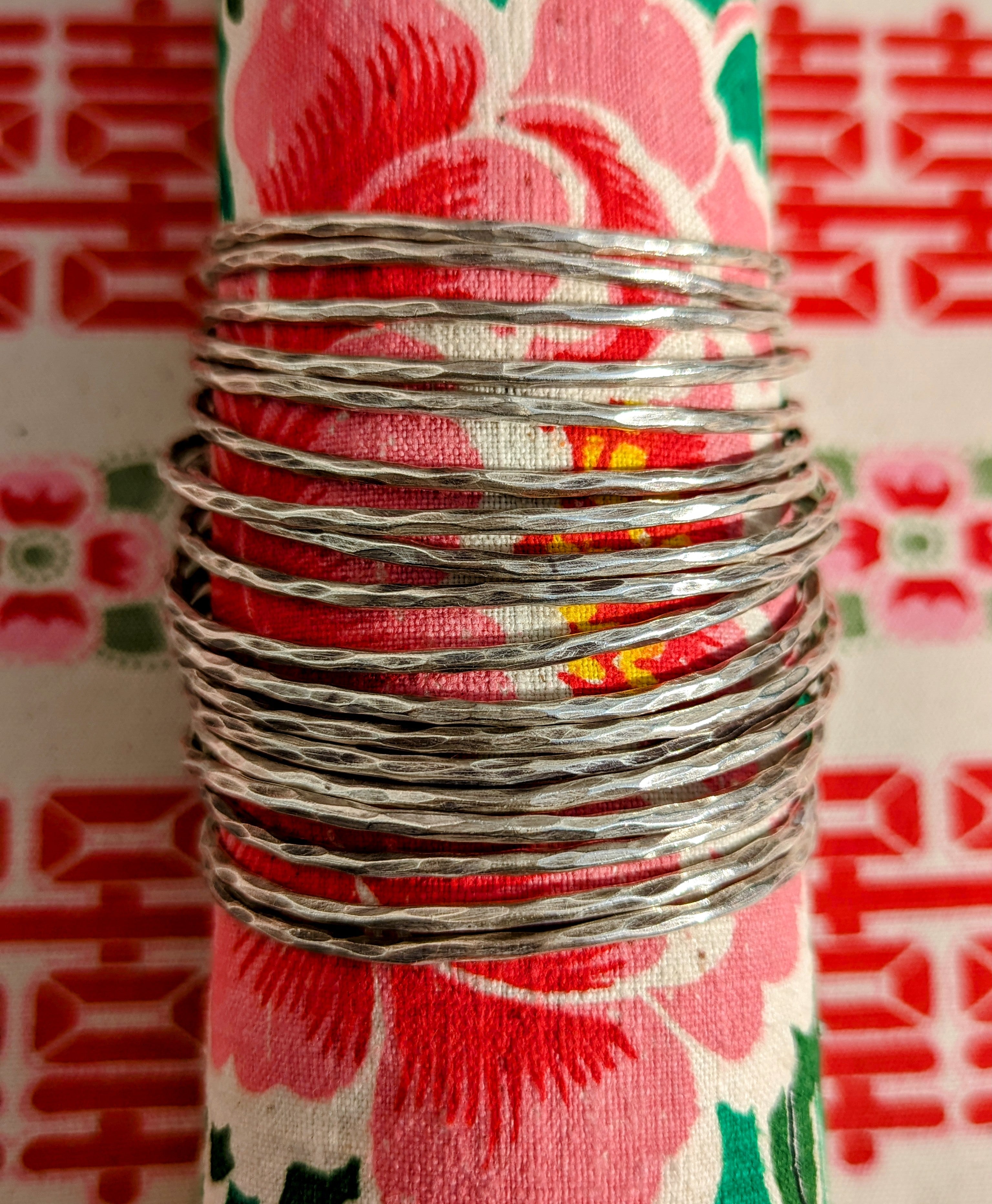 Beautiful patina in these hammered traditional bangles, soft, chunky, hand worked silver

Karen Hill Tribe silver has a higher content of silver, at 99.5-99.9% compared with sterling silver at 92.5%.

Silver is softt and bends a little with wear, but you can place over a glass or bowl to reshape.

Approx 2mm wide.