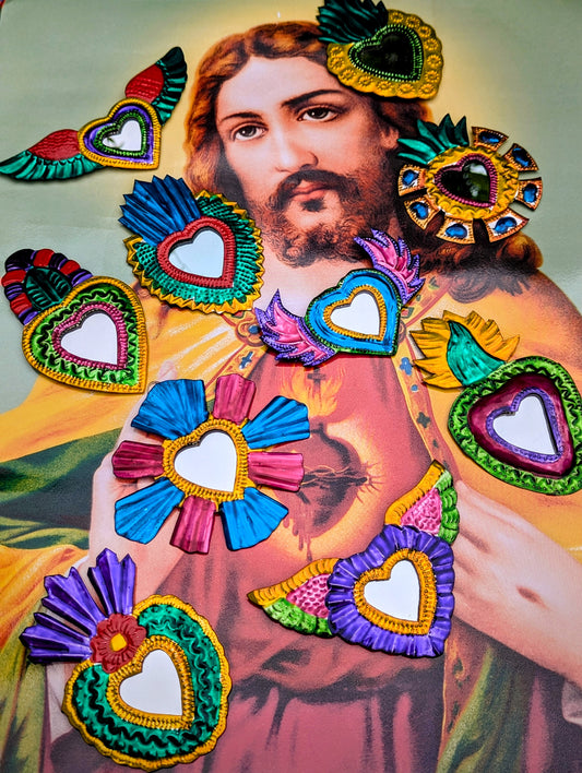 Hand made tin (called poor man's silver in Mexico) sacred heart mirrors made in and around Oaxaca, Mexico. Each piece is hand hammered, and painted,
Variations and rustic handmade imperfections are part of the charm of these pieces.
Approx 11cm diameter on average, sizes vary.
