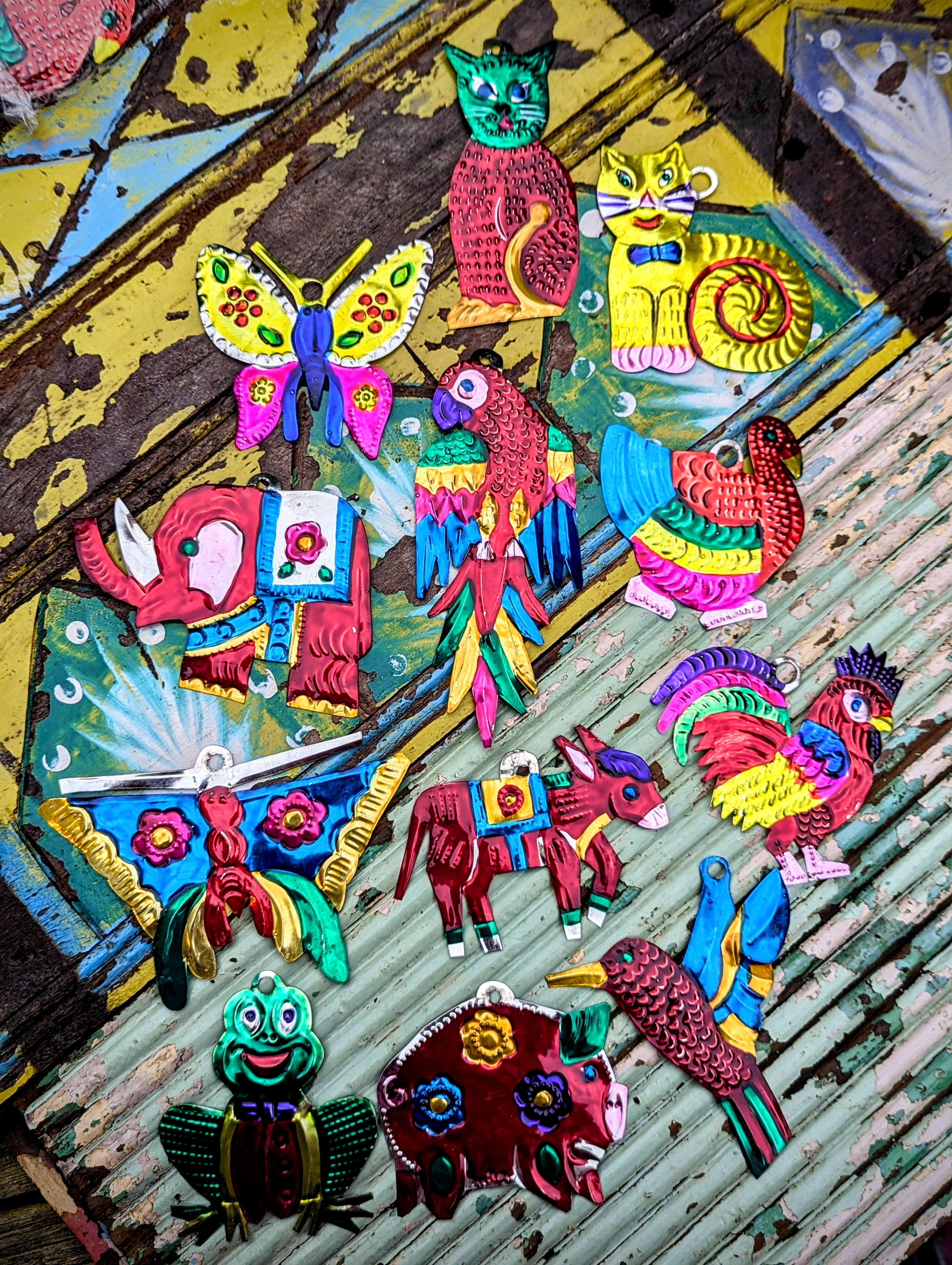 The word Milagros means Miracle. Traditionally milagros are given to saints to ask for a miracle and commonly nailed to the lintel of a door in the home. These milagros have been made by the artisans in Oaxaca to depict all the flora and fauna of Mexico.
Handmade and handpainted tin - all pieces vary in size, and colour. 
Approx 12 cm tall on average

 