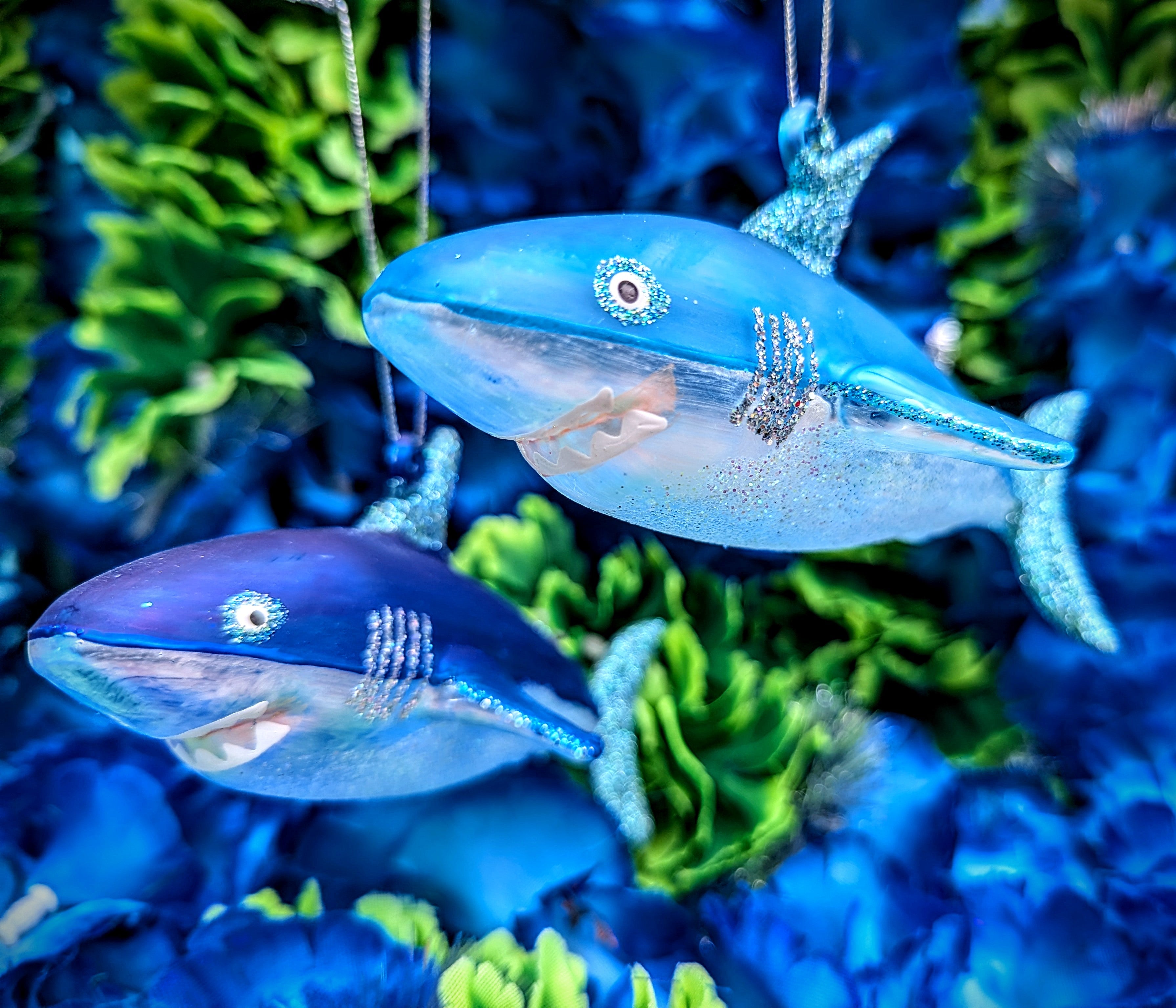 Glorious glittered scary toothful great white shark christmas decoration. Perfect for marine animal lovers. This hand blown ornament is a great addition to your Christmas tree or festive holiday display.

Hand-painted glass

Dimensions 15cm x 7cm x 8cm
Cody foster and co 
Shark bauble