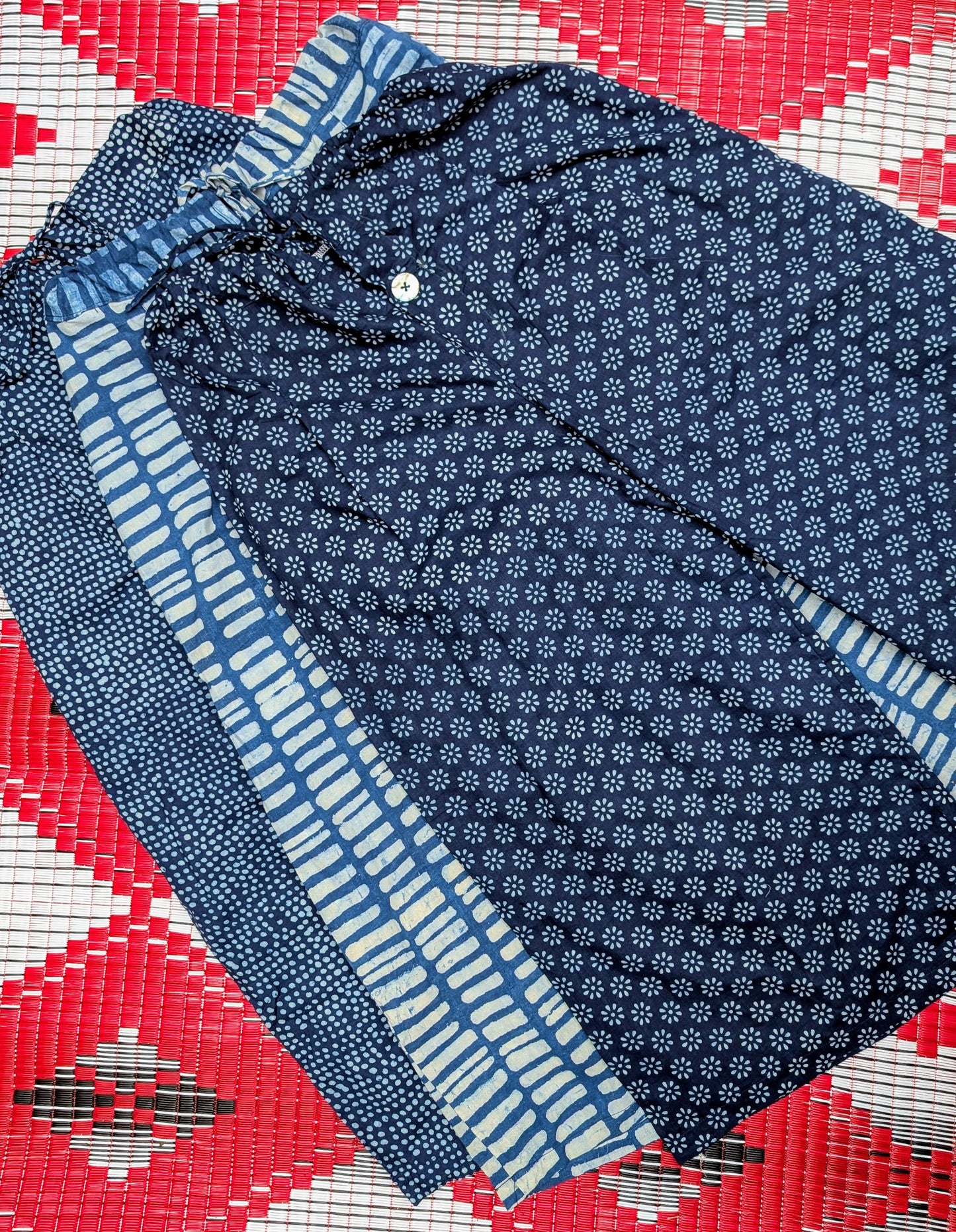 Gorgeous soft fine cotton , hand resist-dyed in  natural indigo using block prints, the fabric is handmade in India, then it is taken and.made in Thailand working with the same family of seamstresses for 25 years. Patterns and sampling made here in the UK by our founder Anna Moody.

One Size (10-14) 

Button fly

Waist when untied- 17 inches

Length - 35 inches 

 