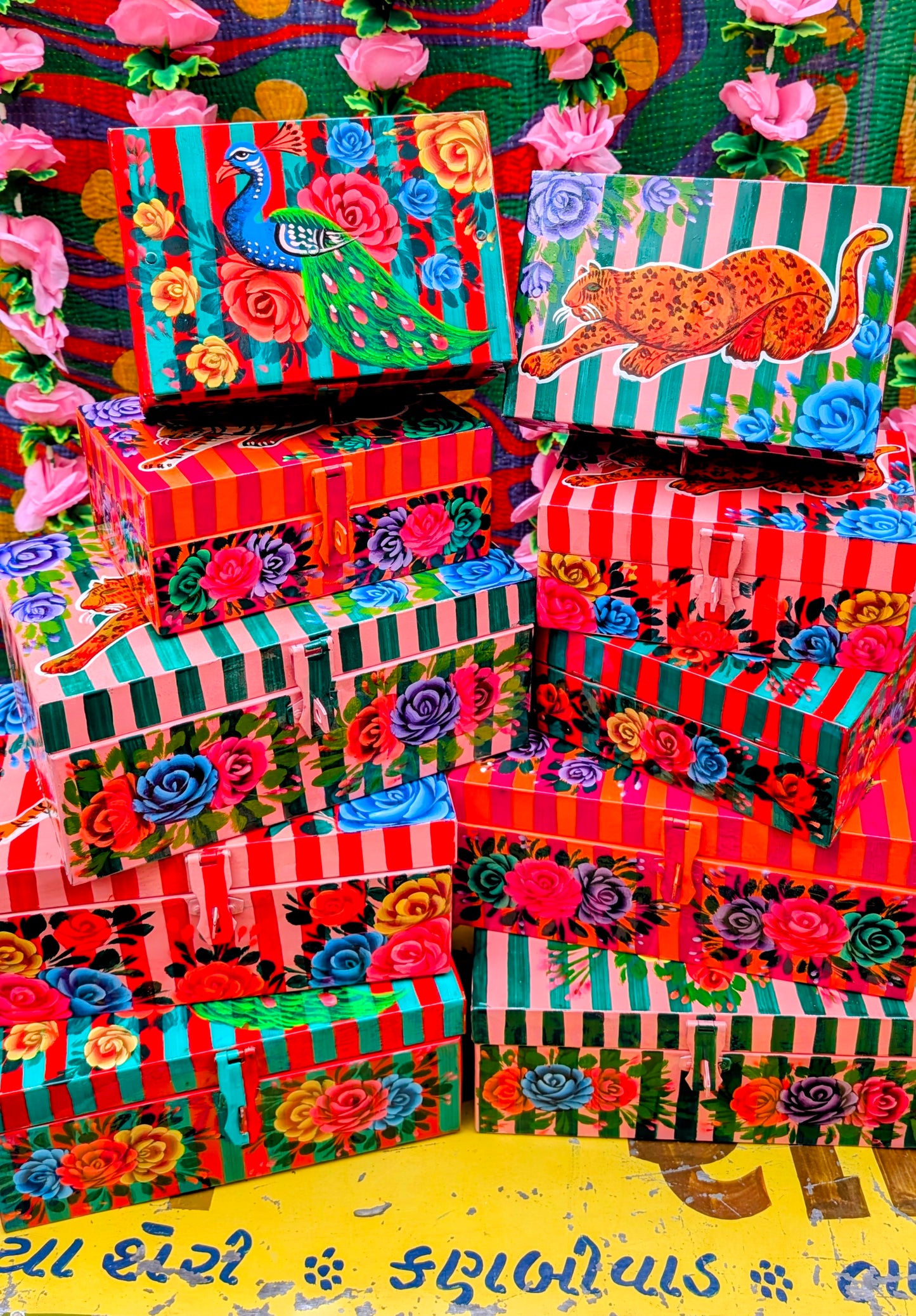 Handpainted in Pakistan by the artisans that paint the fabulously flamboyant trucks! These beautiful boxes are painted with heavy duty enamel paints onto steel cases.Use for jewellery, sewing, knitting, or even just to hide all the paperwork or gubbins you just don't want to see!! Suitable for light cool water washing only. Due to their handmade production, designs may vary and also have imperfections.

Sold individually. 

Dimensions large size are 28cm x 18cm x 12cm

Dimensions small size are 20cm x 14cm 