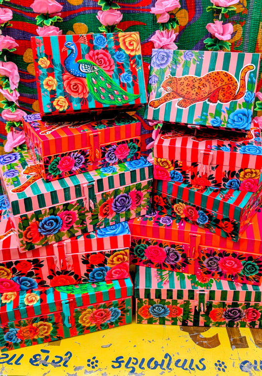 Handpainted in Pakistan by the artisans that paint the fabulously flamboyant trucks! These beautiful boxes are painted with heavy duty enamel paints onto steel cases.Use for jewellery, sewing, knitting, or even just to hide all the paperwork or gubbins you just don't want to see!! Suitable for light cool water washing only. Due to their handmade production, designs may vary and also have imperfections.

Sold individually. 

Dimensions large size are 28cm x 18cm x 12cm

Dimensions small size are 20cm x 14cm 