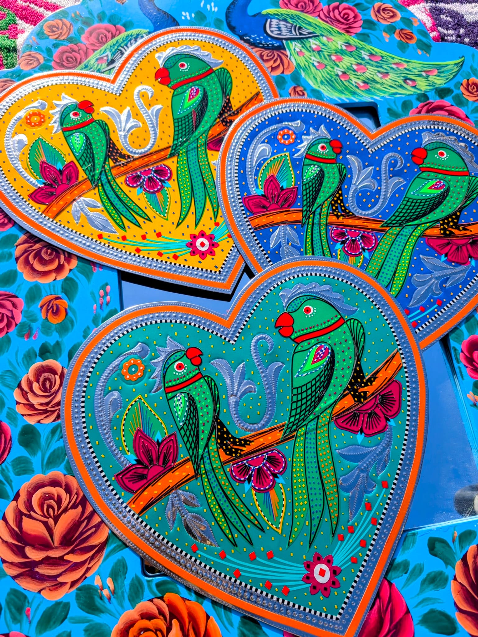 Stunning, sturdy metal love hearts, hand punched and decorated with true loving parakeets depicted in razor cut vinyl by the truck artists of Pakistan

These traditionally are used to decorate the trucks outside or in, and are really beautifully made.

30 x 30cm

Chromed steel, vinyl sticker, fabric backed.

 

 