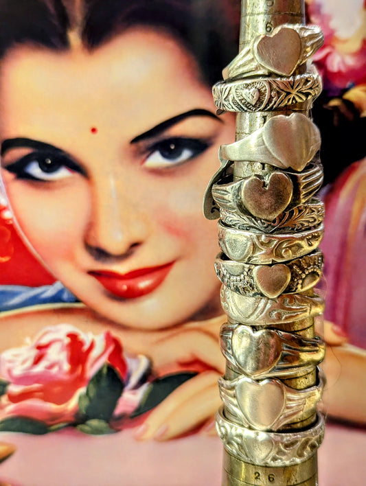 1980s Rajasthani heart rings, handmade in and around Pushkar from silver with incised details.
Some work for many years, wearing away the original design beautifully.

These pieces vary in wear and tear, so please examine images!

Tribal antique silver traditionally has no hallmarks, but all that we sell have an 80-90% content, as these pieces would have been historically made from old melted down jewellery and coins.  

Rings are numbered top to bottom 

Price varies according to weight of silver.