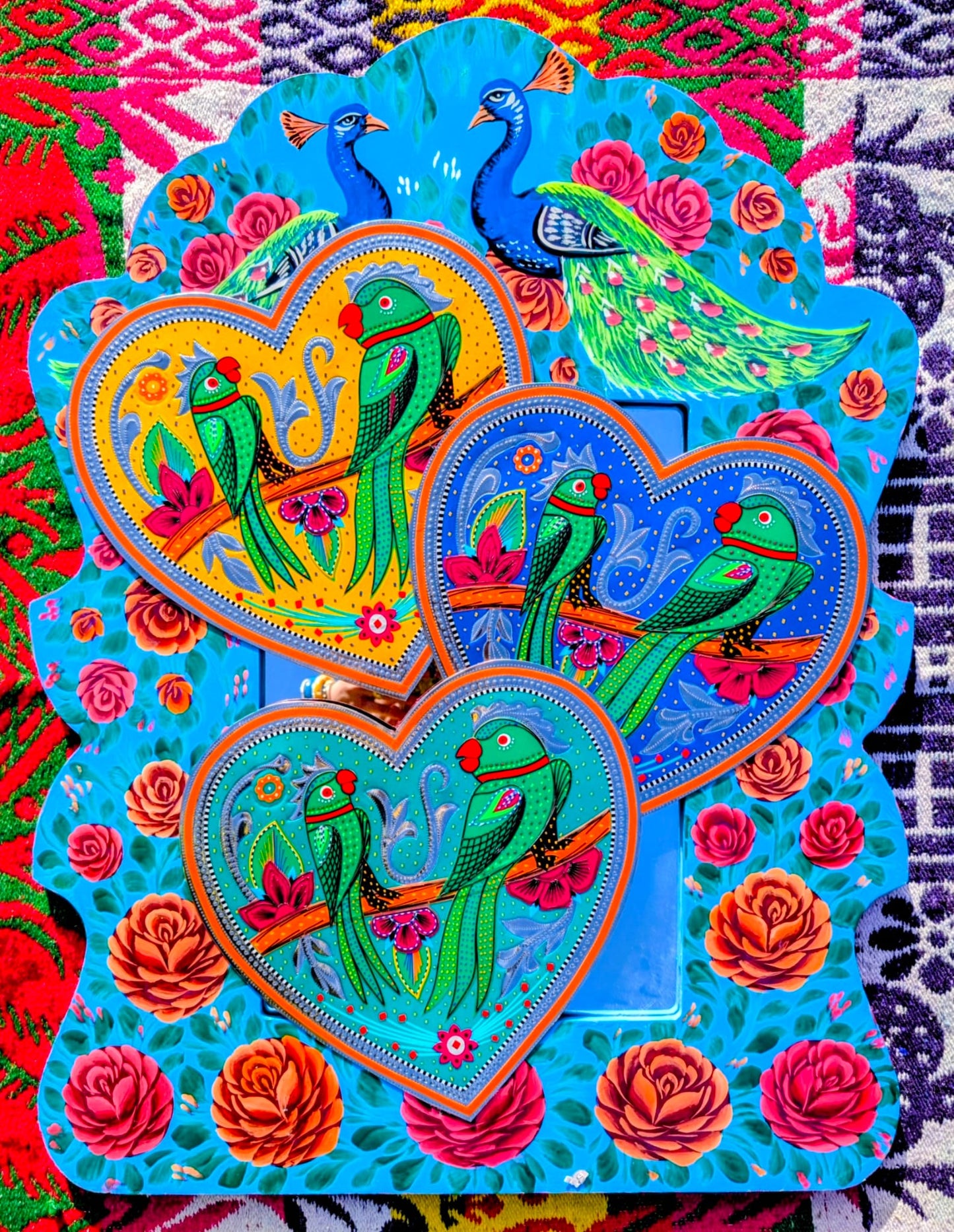 Stunning, sturdy metal love hearts, hand punched and decorated with true loving parakeets depicted in razor cut vinyl by the truck artists of Pakistan

These traditionally are used to decorate the trucks outside or in, and are really beautifully made.

30 x 30cm

Chromed steel, vinyl sticker, fabric backed.

 

 