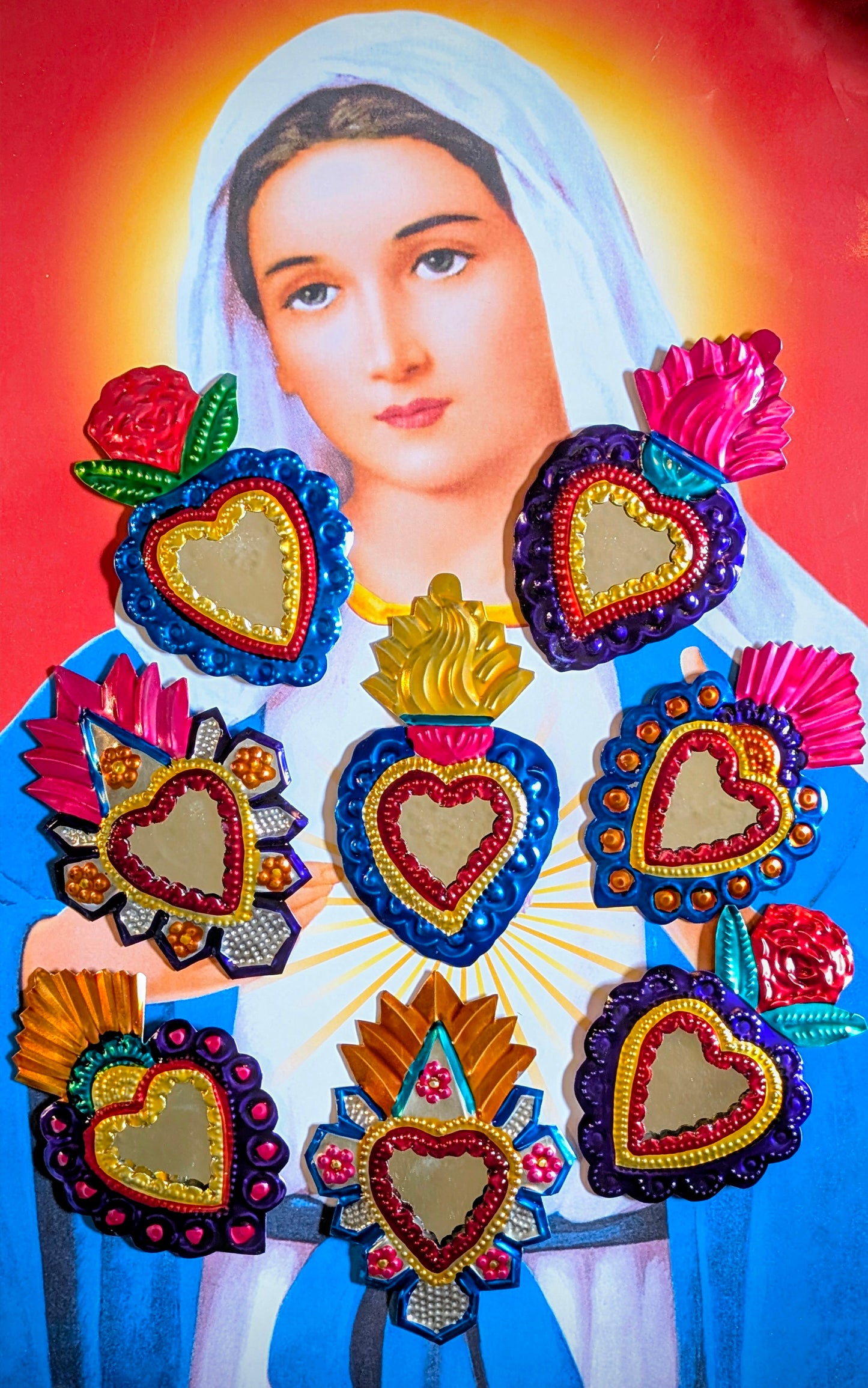 Marvelous Mexican Milagros mirrors!
Hand made tin (called poor man's silver in Mexico) sacred heart mirrors made in and around Oaxaca, Mexico. Each piece is hand hammered, and painted.
Variations and rustic handmade imperfections are part of the charm of these pieces.
Approx 14cm x 9cm.
Tin and glass mirror.
