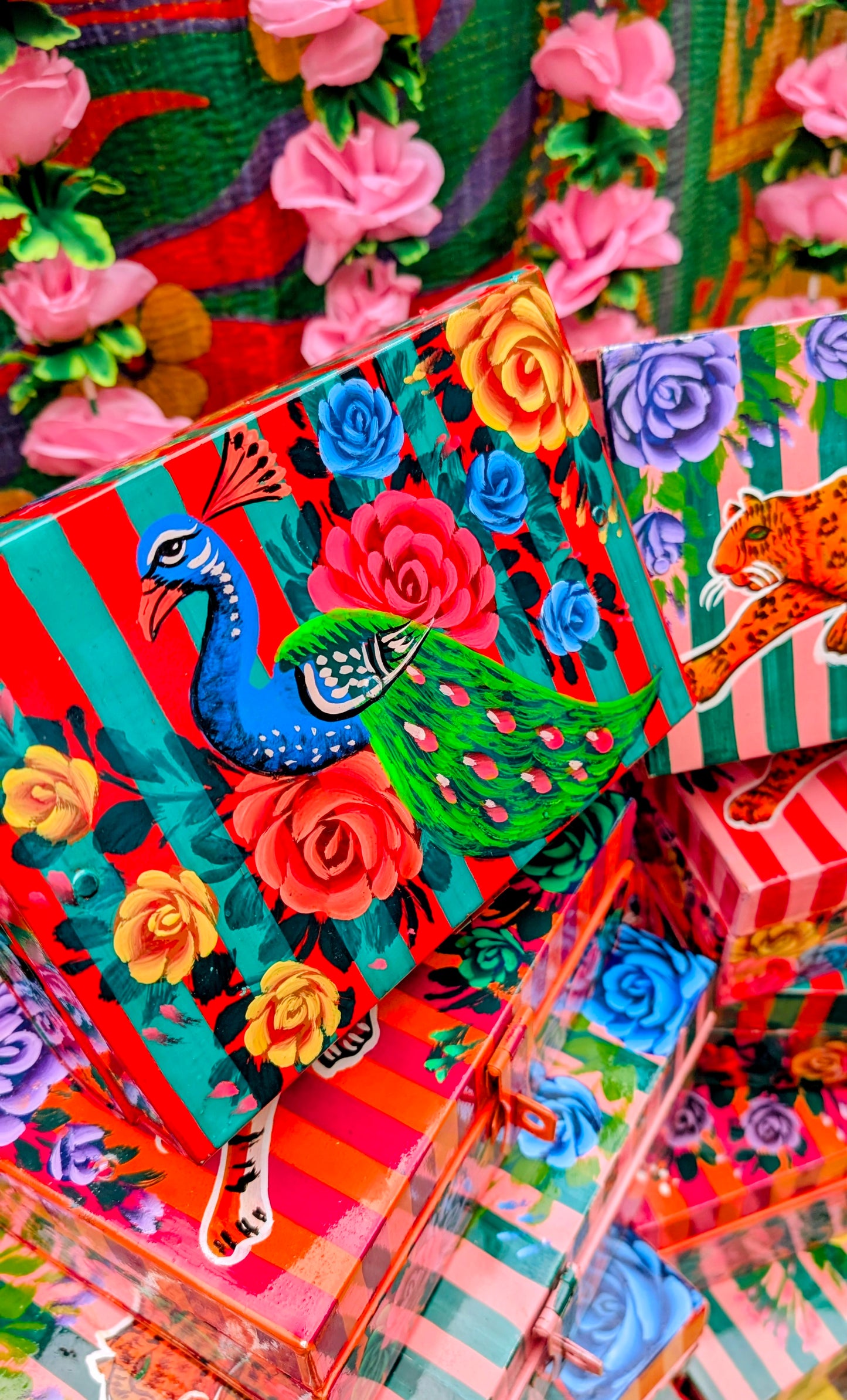 Handpainted in Pakistan by the artisans that paint the fabulously flamboyant trucks! These beautiful boxes are painted with heavy duty enamel paints onto steel cases.Use for jewellery, sewing, knitting, or even just to hide all the paperwork or gubbins you just don't want to see!! Suitable for light cool water washing only. Due to their handmade production, designs may vary and also have imperfections.

Sold individually. 

Dimensions large size are 28cm x 18cm x 12cm

Dimensions small size are 20cm x 14cm 