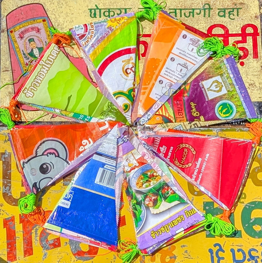 Bunting made from recycled rice sacks in Thailand.

Each bunting length comes with 17 flags and measures 6 metres approx.

Flags are 32cm long and 20cm wide. Rice sack designs vary throughout.