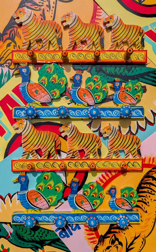 Skillfully handpainted wooden hooks all the way from the talented artisans of Rajasthan.

Great way of organising your jewellery or typically use for your keys, hats, jackets or necklaces?!

Available in tiger and peacock designs

Approx 35 cm long and 14cm high, 5 hooks. 

 

 