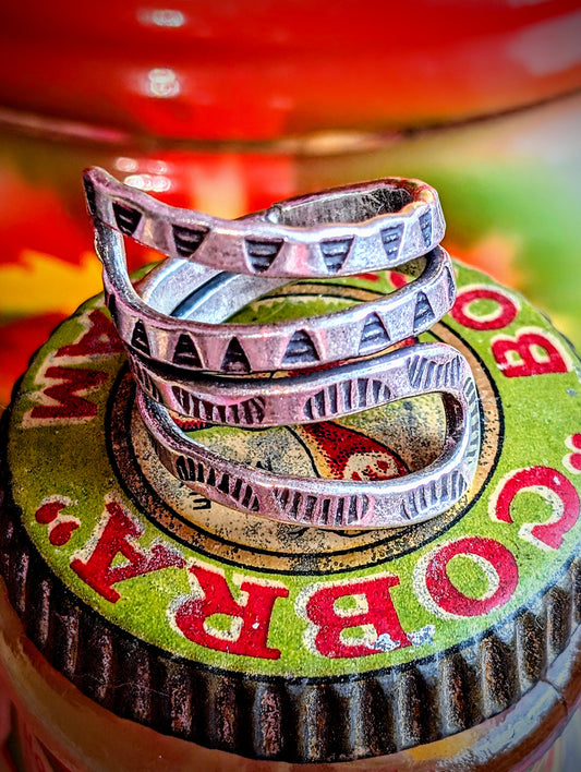 Snakey, sculptural, stamped rings. Available in sizes, but these are such soft silver they can be stretched or coiled in to fit. All pieces are hand made and hand finished using traditional methods.
Hill tribe silver has a higher content of silver, at 99.5-99.9% compared with sterling silver at 92.5%. This allows the silver to wear and soften differently from standard sterling silver. All pieces are hand made and hand finished using traditional methods. The texture in these pieces show the malleable nature 