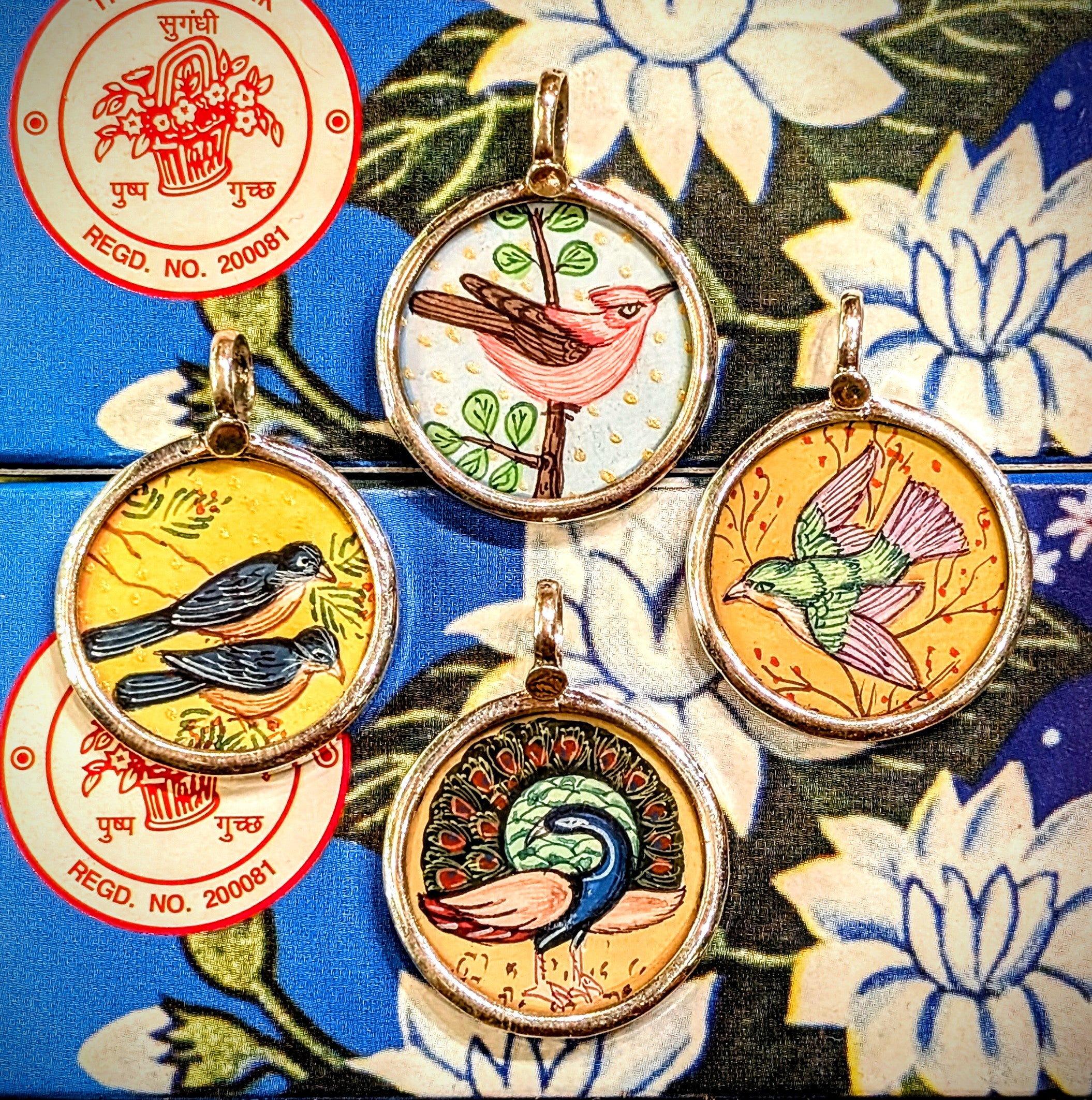 Free flying birds symbolising beauty,  grace, freedom, peace and as messangers between the divine and earth.
Made in Rajasthan, these pendants are crafted from sterling silver, glass and hand painted images on paper. The fine craftsmanship in these paintings is mind blowing, painting with single paint brush bristles!!!

These pendants should be removed when washing/swimming etc as they are in effect framed pieces of art, that although sealed are not water tight! 
Size 25mm diameter and 7mm loop.
