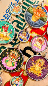 Holy Hindu gods to protect and inspire!
Ganesha is the much beloved , elephant headed god of wisdom, prosperity , good fortune and new beginnings, revered as the  Remover of Obstacles in both material and spiritual life, and his presence is invoked before undertaking any new activity or project, from starting a journey to commencing a marriage. He is often depicted with a clever rat as his mount and helper!

Made in Rajasthan, these pendants are crafted from sterling silver, glass and hand painted images on