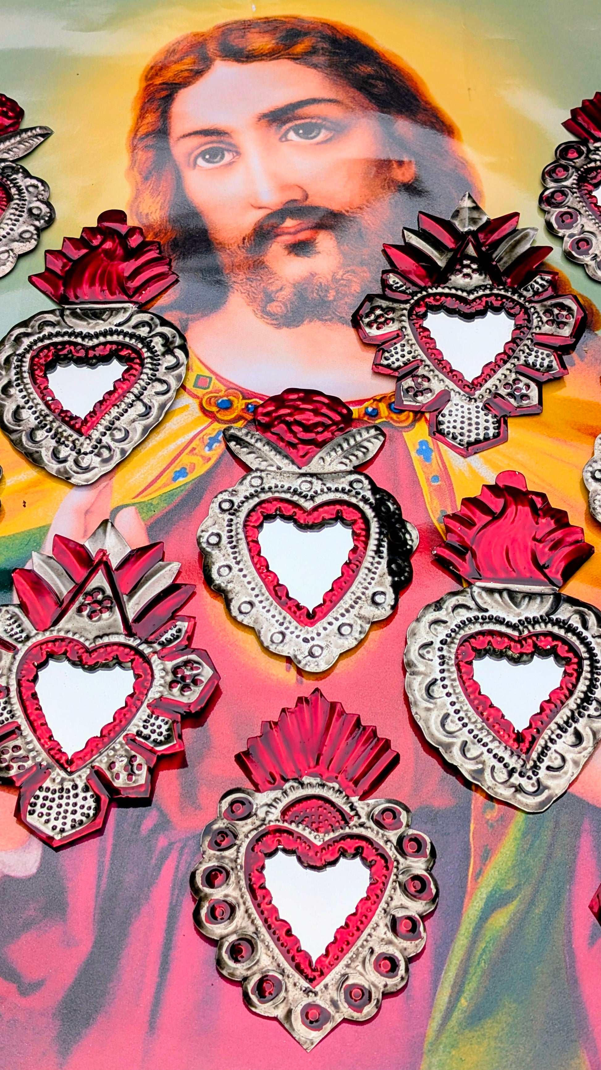 Marvelous Mexican Milagros mirrors!
Hand made tin (called poor man's silver in Mexico) sacred heart mirrors made in and around Oaxaca, Mexico, representing the Virgin Mary and her healing and helping heart.
Each piece is hand hammered, and painted.
Variations and rustic handmade imperfections are part of the charm of these pieces.
Approx 14cm x 9cm.
Tin and glass mirror.
