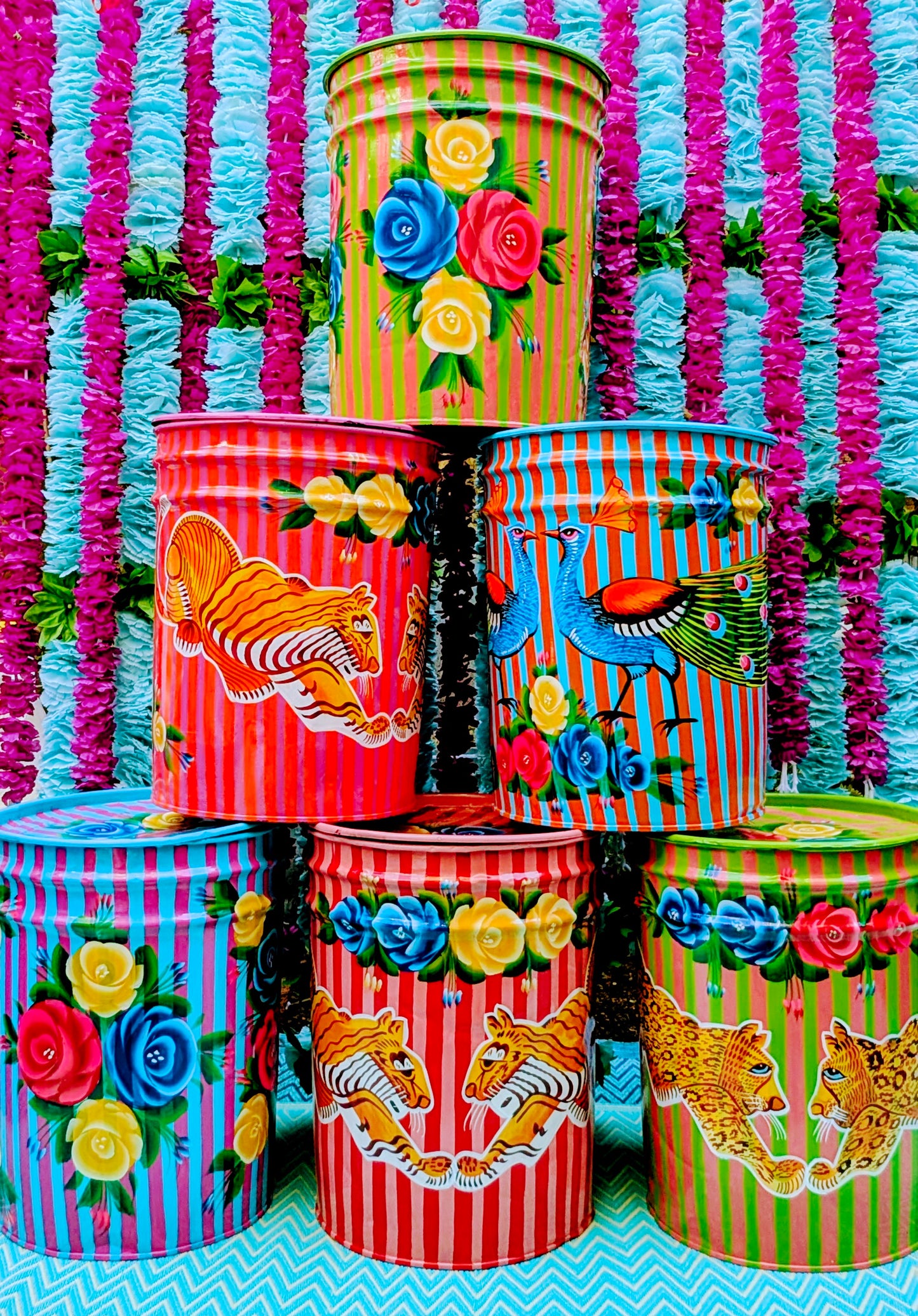 Handpainted in Pakistan by the artisans that paint the fabulously flamboyant trucks! These barrels are recycled oil and paint drums painted with heavy duty enamel paints.They make great stools, side tables and fabulous storage!

Suitable for light cool water washing only. Due to their handmade and recycled nature, designs may vary and also have imperfections and dents.

Dimensions are 47cm tall and 36cm diameter across the top

 
