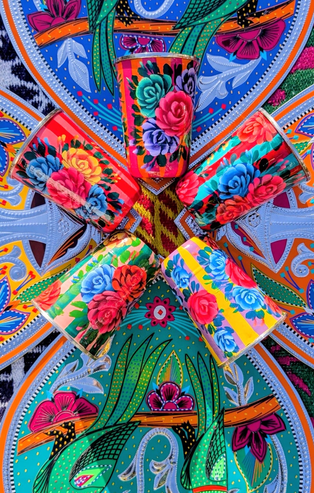  Handpainted in Pakistan by the artisans that paint the fabulously flamboyant trucks! These stainless steel beakers are painted with heavy duty enamel paints onto lassi cups. Suitable for light cool water washing only.

Due to their handmade production, designs may vary and also have imperfections.

Dimensions 10cm high, 7.5cm diameter 
 