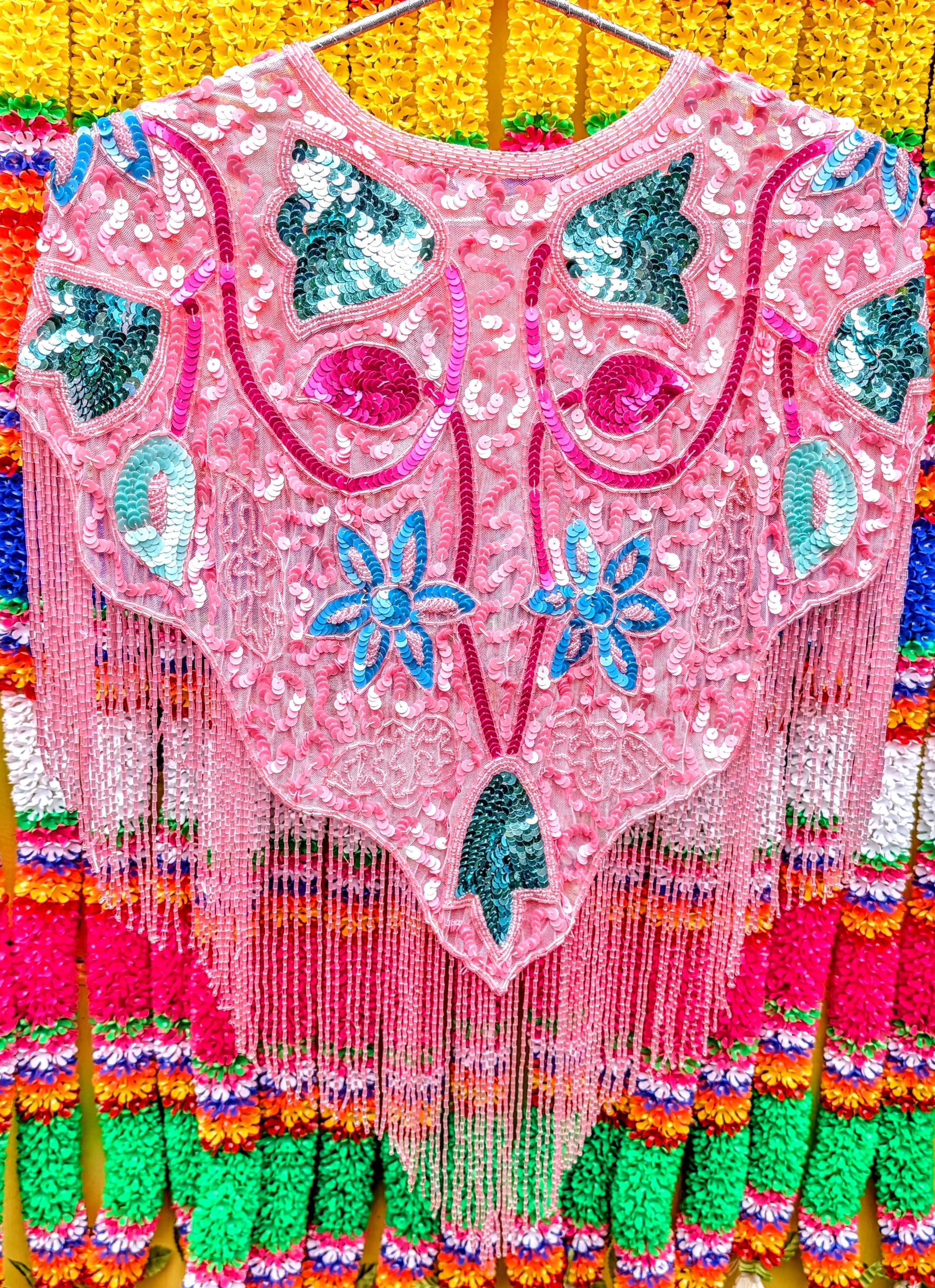 Folky florals in neon pastel brights for maximum fun and colour!!!.....this sequin cape will turn any....any ...outfit into a party outfit, sling it on over dresses, jumpsuits, T-shirts, whatever, and you will feel and look fabulous!!..then get on out to a party, festival or performance!!

One size fits all

All beads and sequins are securely sewn, pack away gently when not in use, and this will see many parties for years to come!!

 