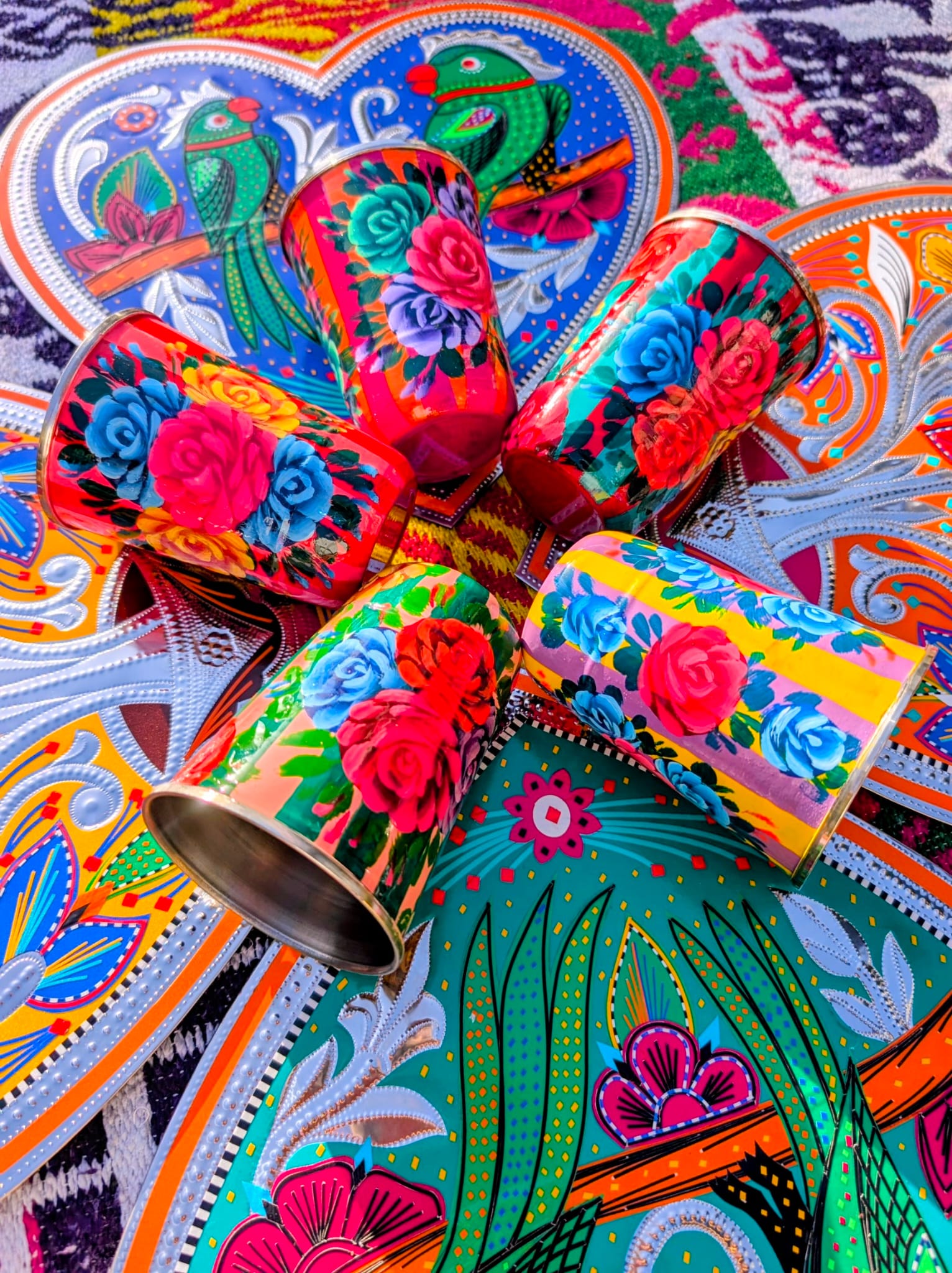  Handpainted in Pakistan by the artisans that paint the fabulously flamboyant trucks! These stainless steel beakers are painted with heavy duty enamel paints onto lassi cups. Suitable for light cool water washing only.

Due to their handmade production, designs may vary and also have imperfections.

Dimensions 10cm high, 7.5cm diameter 
 