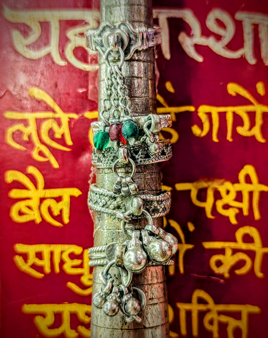 The ladies of the desert like bells on their fingers and bells on their toes, ears, belts and ankle bracelets too!!

1960s-80s Rajasthani rings, handmade in and around Pushkar from silver.
Numbered from top to bottom.
These pieces vary in wear and tear, so please examine images!

Tribal antique silver traditionally has no hallmarks, but all that we sell have an 80-90% content, as these pieces would have been historically made from old melted down jewellery and coins.  
