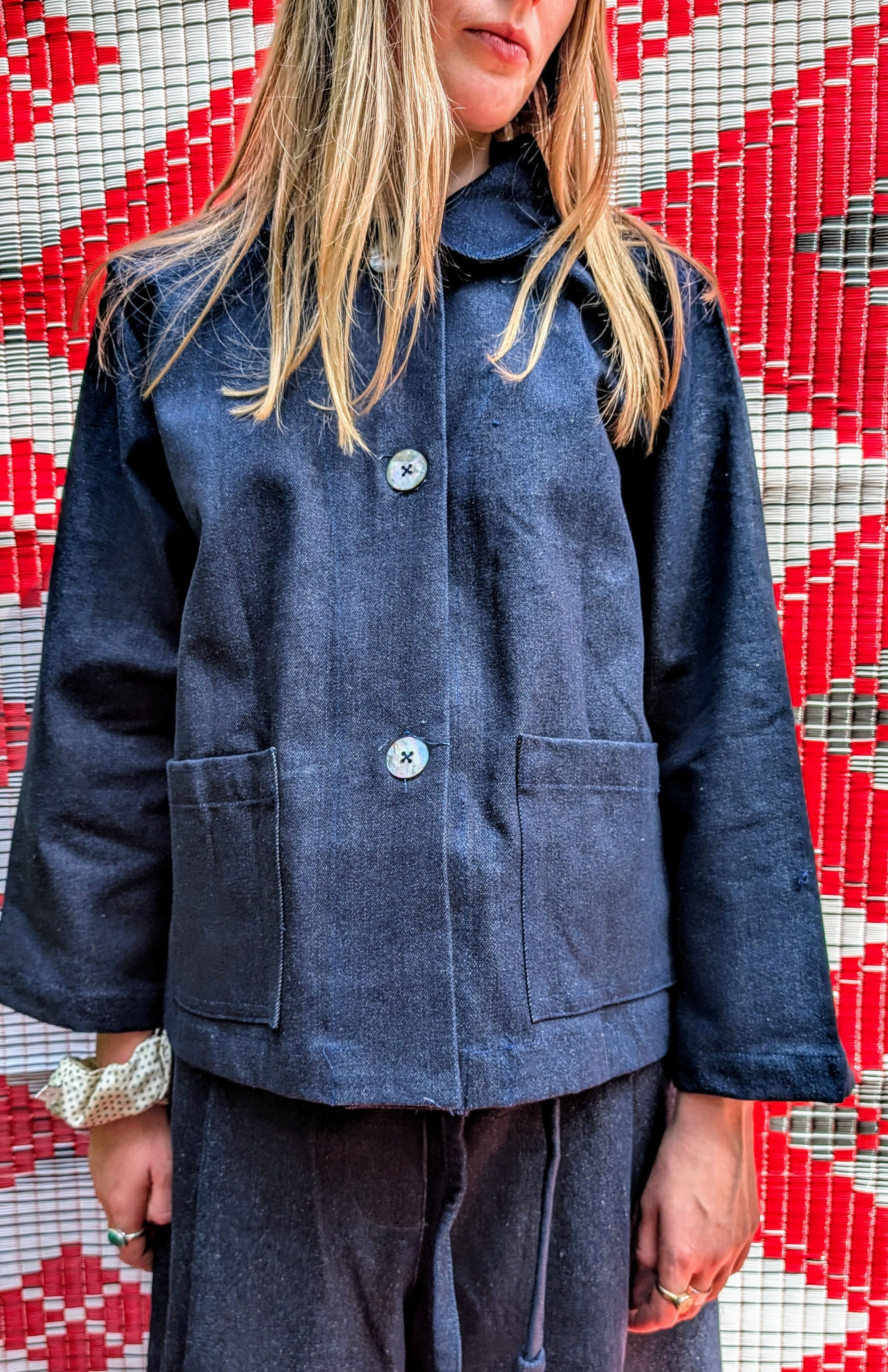 Fabulous heavy weight dark Japanese denim jacket.

Classic boxy shape with mother of pearl buttons, two front pockets and cute collar.

Handmade in Thailand working with the same family of seamstresses for 25 years. Patterns and sampling made here in the UK by our founder Anna Moody.

Available in two sizes 

Size 1 - length 24" / bust 44"

Size 2 - length 24 " / bust 50"

Please note, we can only issue store credit notes for online sale returns. 

 Pippa is pictured in a size 2