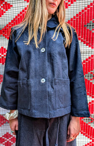 Fabulous heavy weight dark Japanese denim jacket.

Classic boxy shape with mother of pearl buttons, two front pockets and cute collar.

Handmade in Thailand working with the same family of seamstresses for 25 years. Patterns and sampling made here in the UK by our founder Anna Moody.

Available in two sizes 

Size 1 - length 24" / bust 44"

Size 2 - length 24 " / bust 50"

Please note, we can only issue store credit notes for online sale returns. 

 Pippa is pictured in a size 2