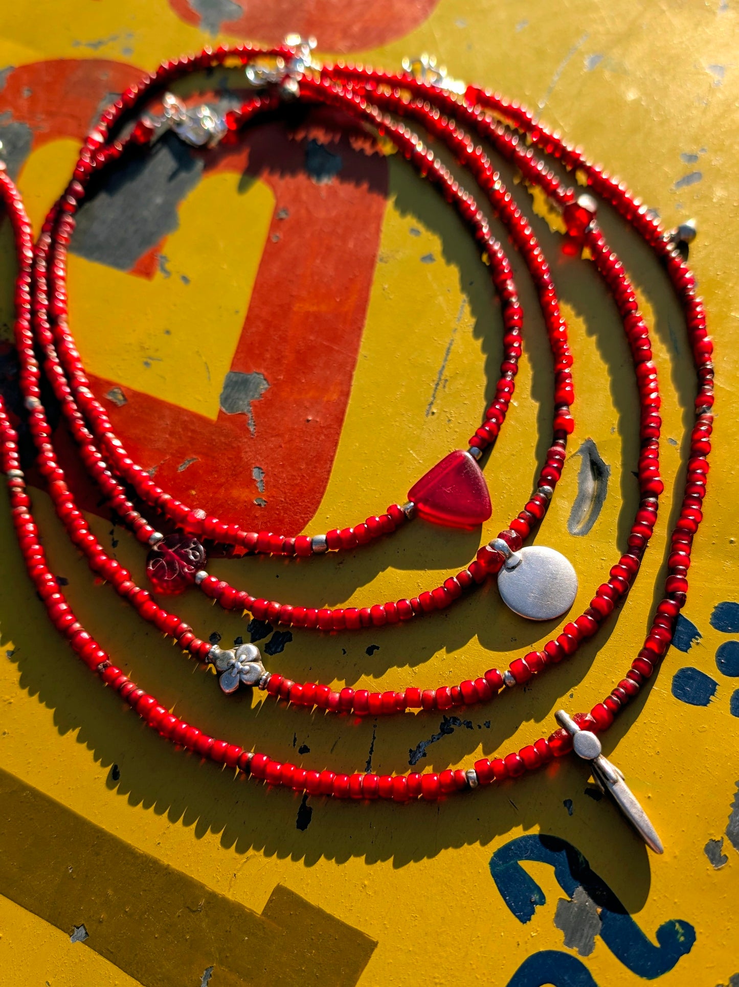 A collection of necklaces made with antique glass beads, antique silver pendants, all unique and different and made by us!

. The red beads are Venetian 19th C white hearts,which were called that as they are a layer of red glass over white.

Lengths are approx 17 inches.