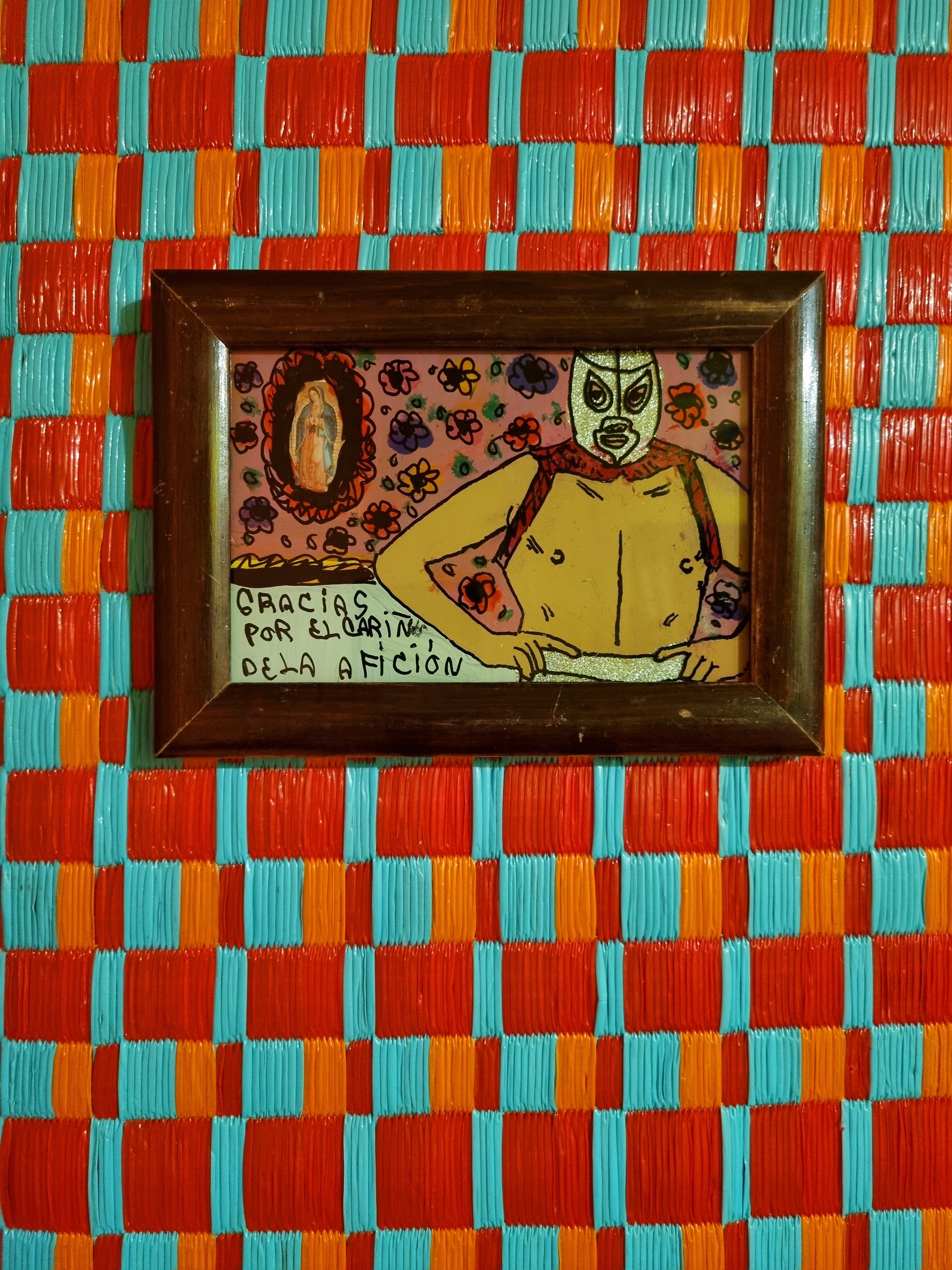 Original luchador reverse glass paintings by Manuel Bauman