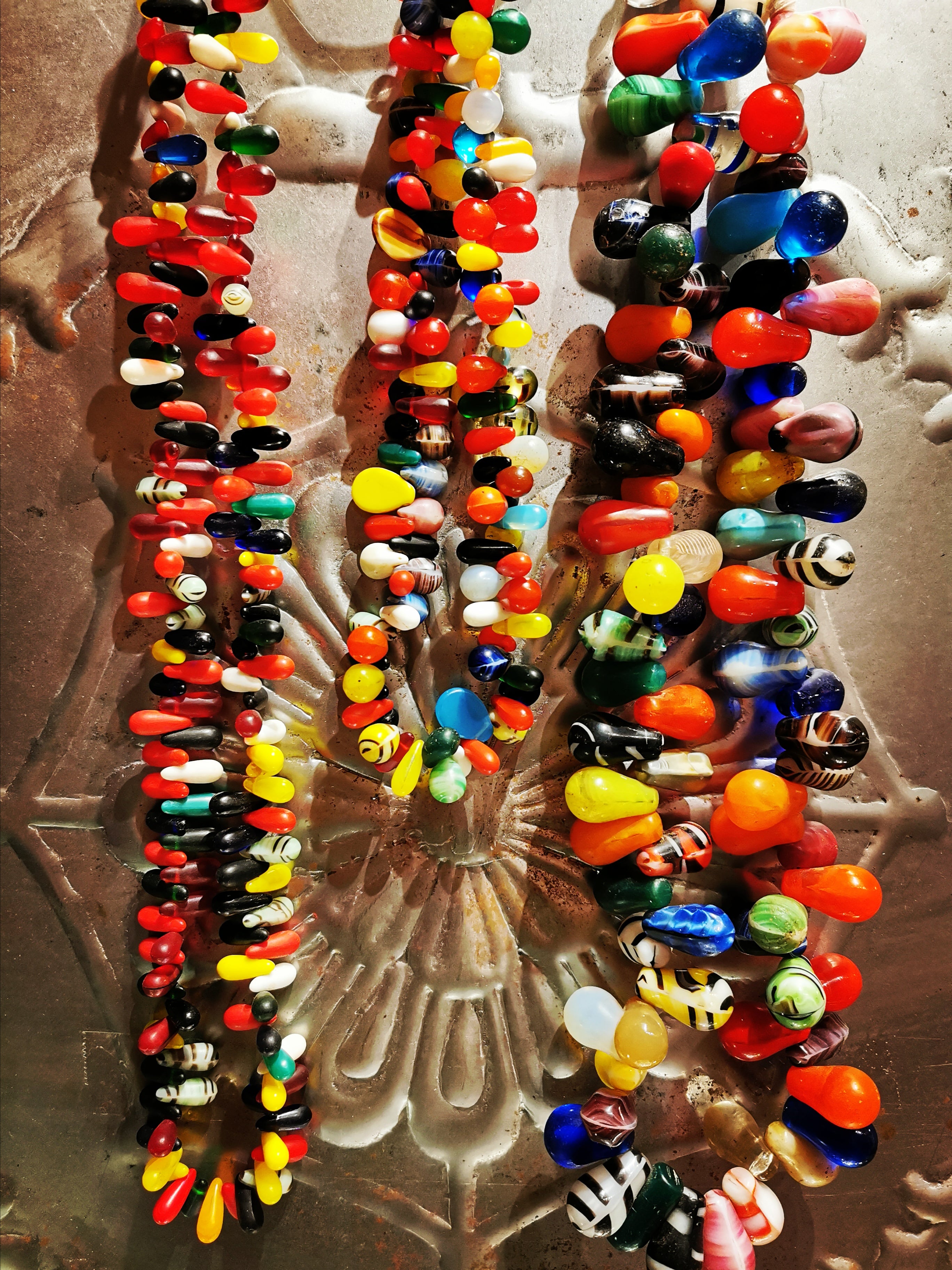 Beautiful age worn glass trade beads made between 1830 and 1932 in Bohemia for trade with the Fulani and Peul in Mali.These were bought and used as dowry beads,and the super modern looking designs were based on the original dowry beads from the area that would have been made in local agates.

 

