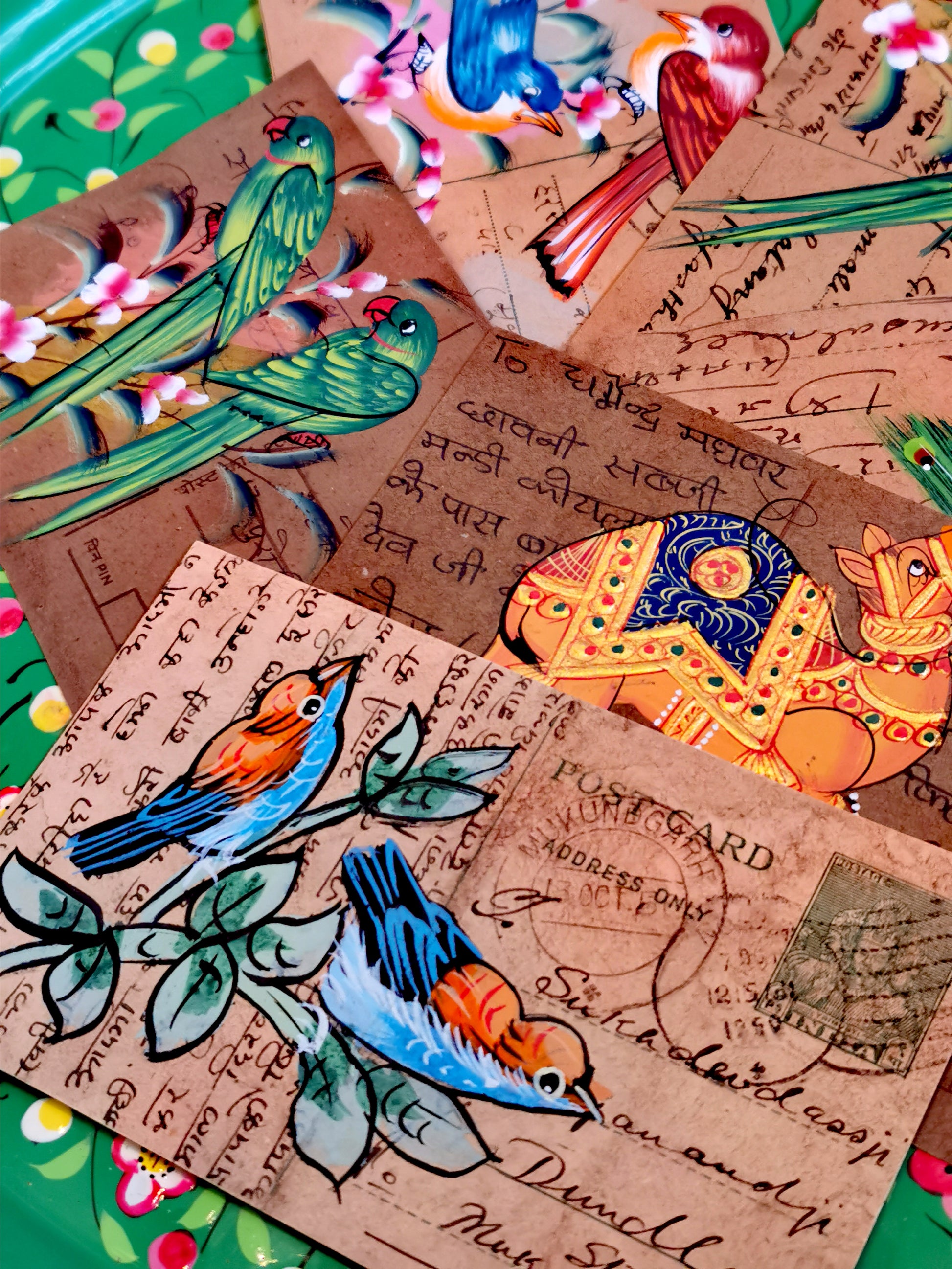 This form of painting in India is typically undertaken by the apprentices learning to paint miniatures. They often used recycled documents, letters and in this case postcards. All are original pieces.



