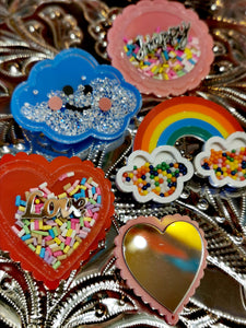 Super kitsch brooches to cheer up a coat or cardie,a rainbow for the NHS, Happy as hope! and the mirror one is fab for checking your lipstick!.

Acrylic /mirror /sprinkles

Designs vary in size but approx 5.5cm

