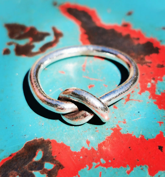 Karen hill tribe silver has a higher content of silver, at 99.5-99.9% compared with sterling silver at 92.5%. This allows the silver to wear and soften differently from standard sterling silver. Many of the Karen ring designs stack together beautifully. All pieces are hand made and hand finished using traditional methods.


 

A knot to remember, a symbol recognised the world over. 

 

