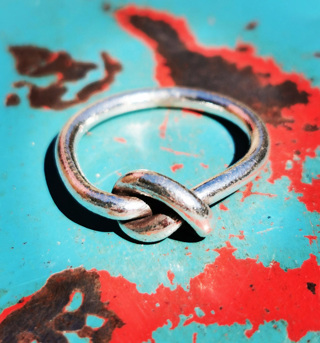 Karen hill tribe silver has a higher content of silver, at 99.5-99.9% compared with sterling silver at 92.5%. This allows the silver to wear and soften differently from standard sterling silver. Many of the Karen ring designs stack together beautifully. All pieces are hand made and hand finished using traditional methods.


 

A knot to remember, a symbol recognised the world over. 

 

