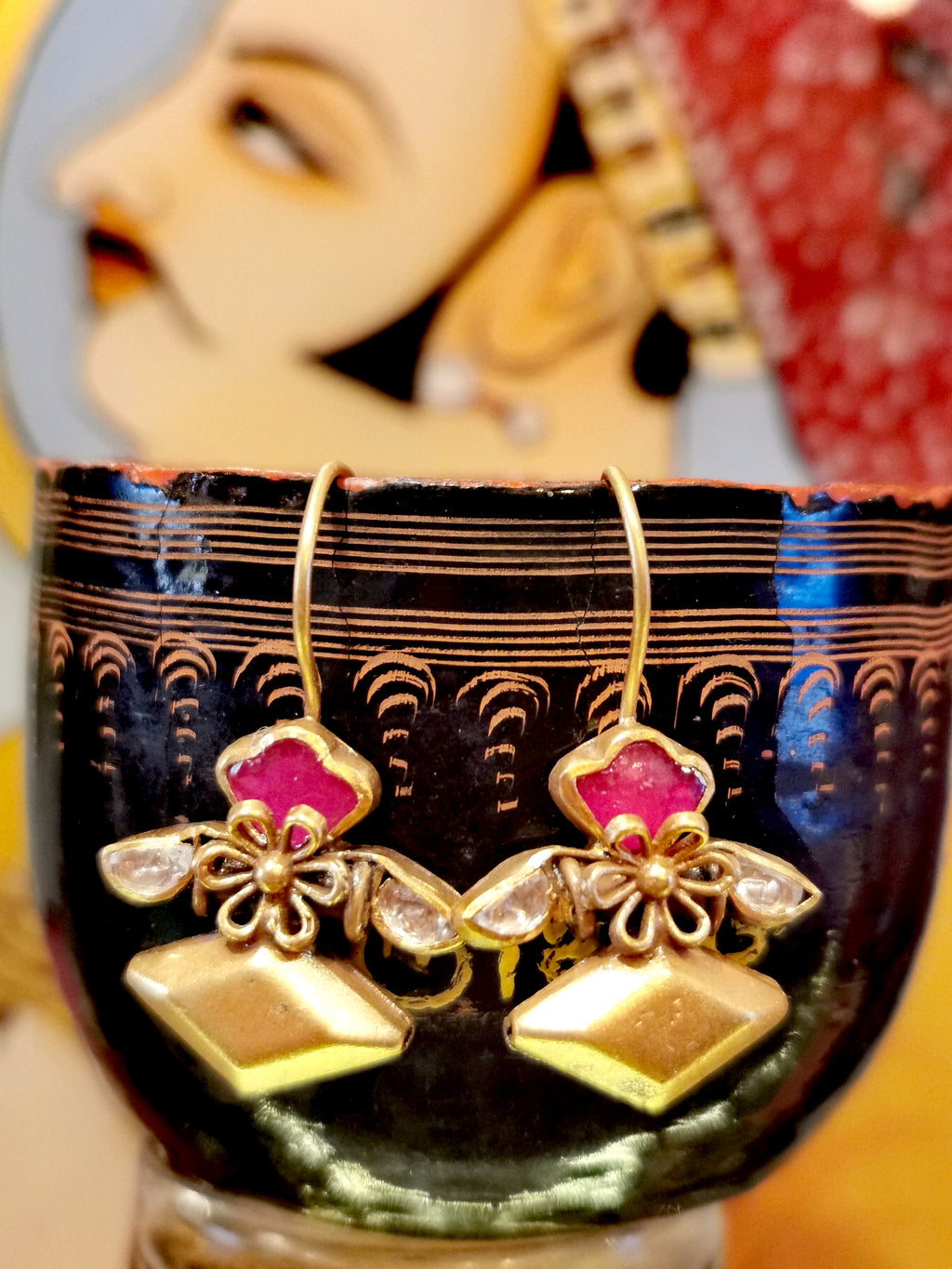 Inspired by traditional Mughal jewellery from the North of India, these gorgeous earrings have a matte gold finish amulet design set with cut crystals. 

Gold plated silver, crystal. 

