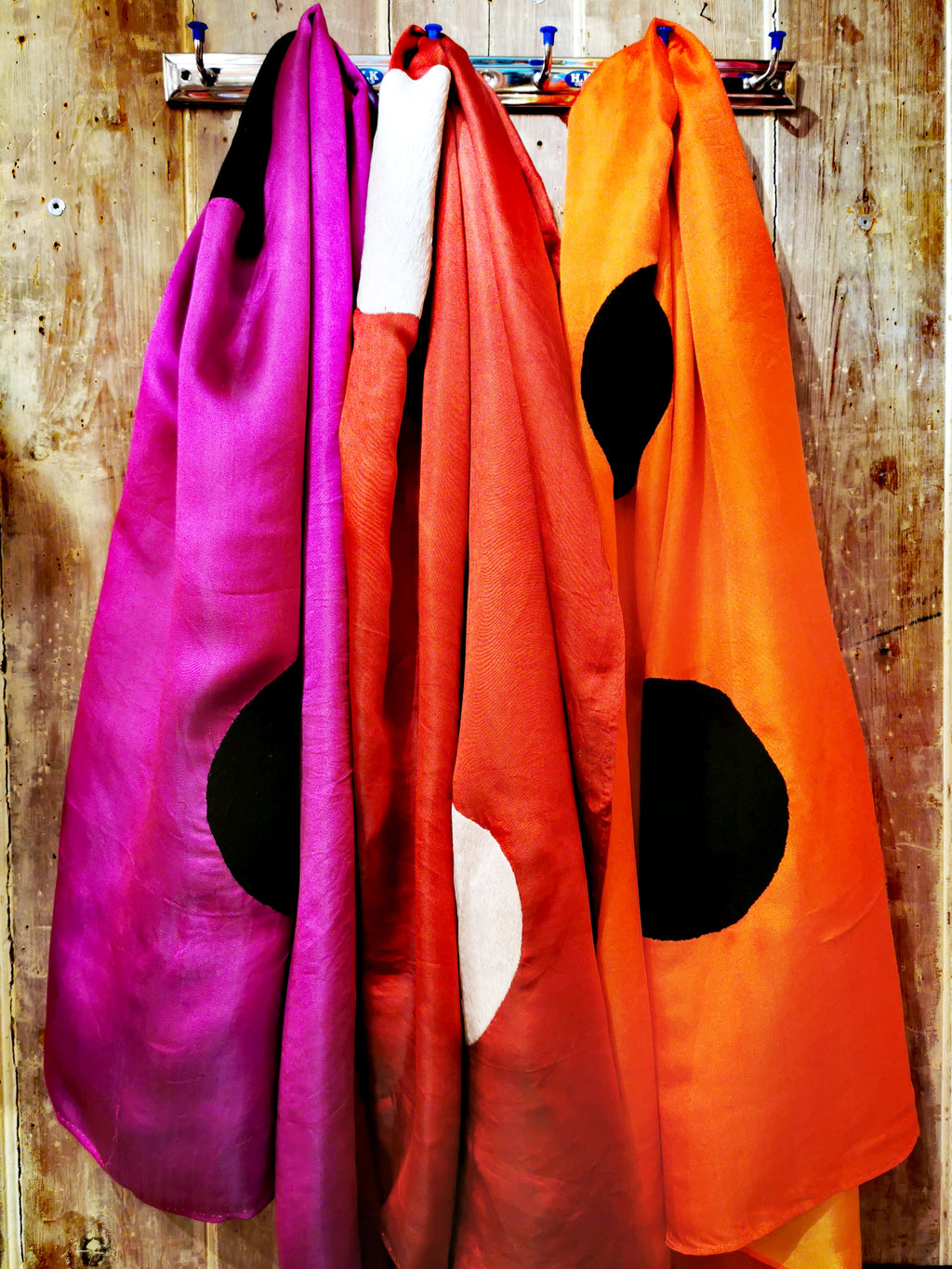 Super luxe silk satin shawls in gorgeous colours woven in Vietnam.Hand embroidered with 3 large polka dots. Long length, so can be wrapped around the neck twice for warmth, thrown over the shoulders or wrapped around the waist as a sarong.

Silk is different colour on the reverse. 

90cm x 180 cm

Hand wash in silk friendly detergent. 

