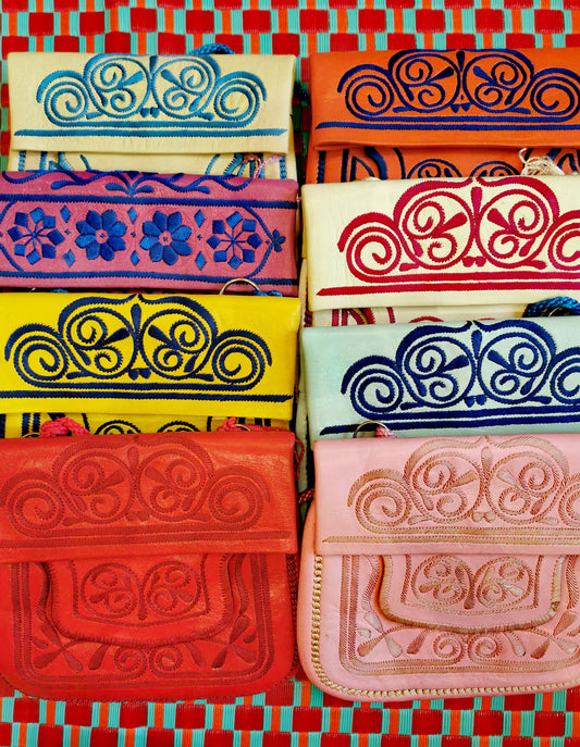Traditional leather handbags hand embroidered in the Atlas Mountains with gorgeous contrasting  designs. 23 x 20 cm  approx with adjustable cord. 

These are handmade in rural areas and so have slight imperfections. 


Berber bags